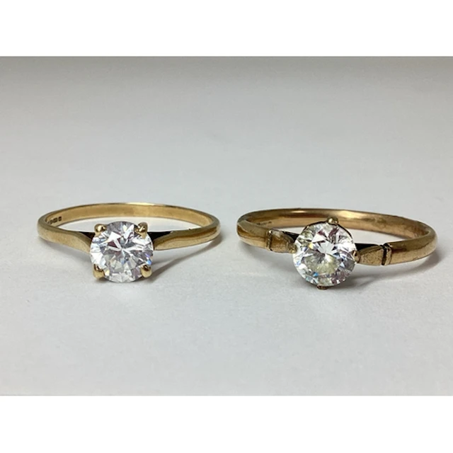 A 9ct Gold Single Stone Ring, four claw set, between plain t...