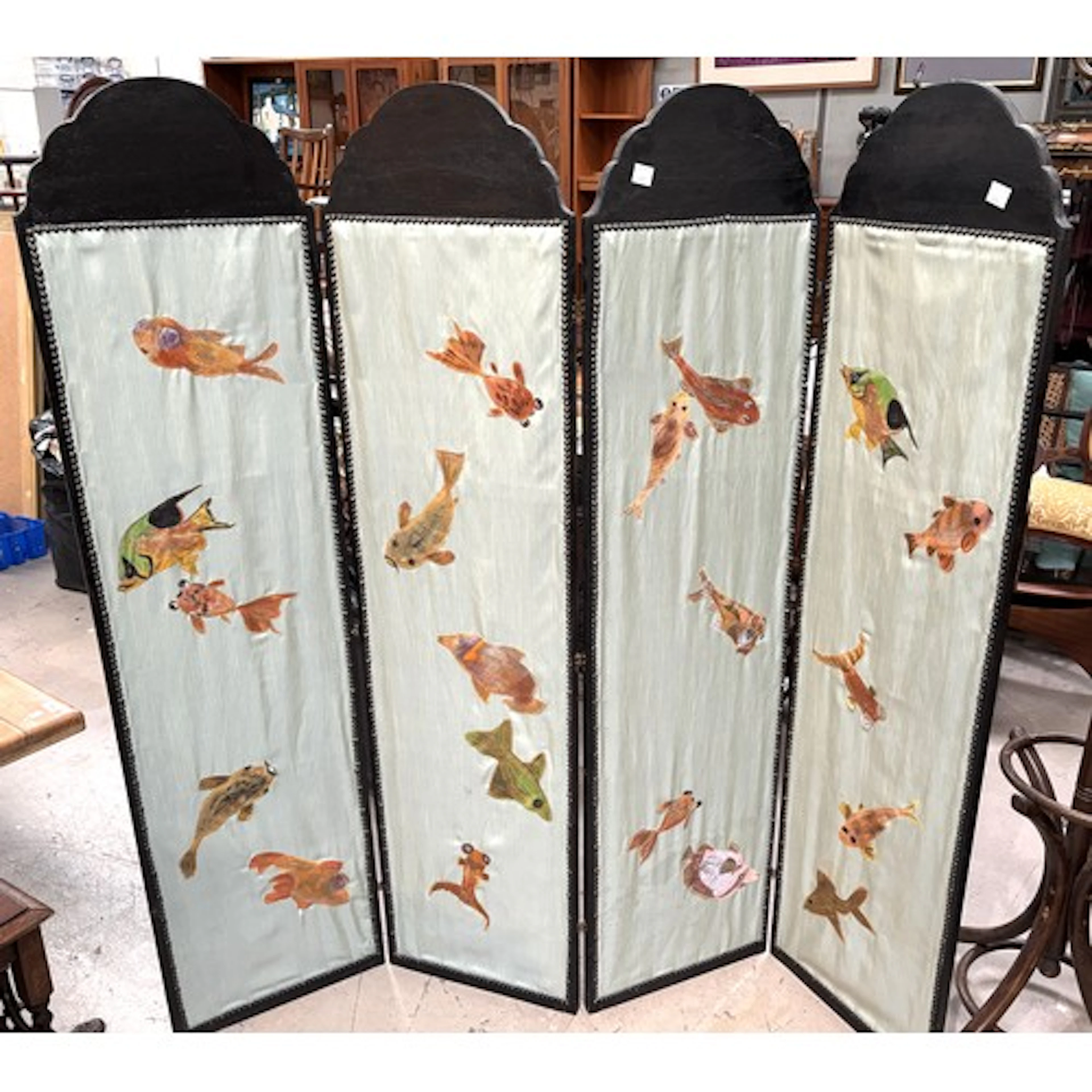 A vintage four fold screen featuring a marine tapestry.