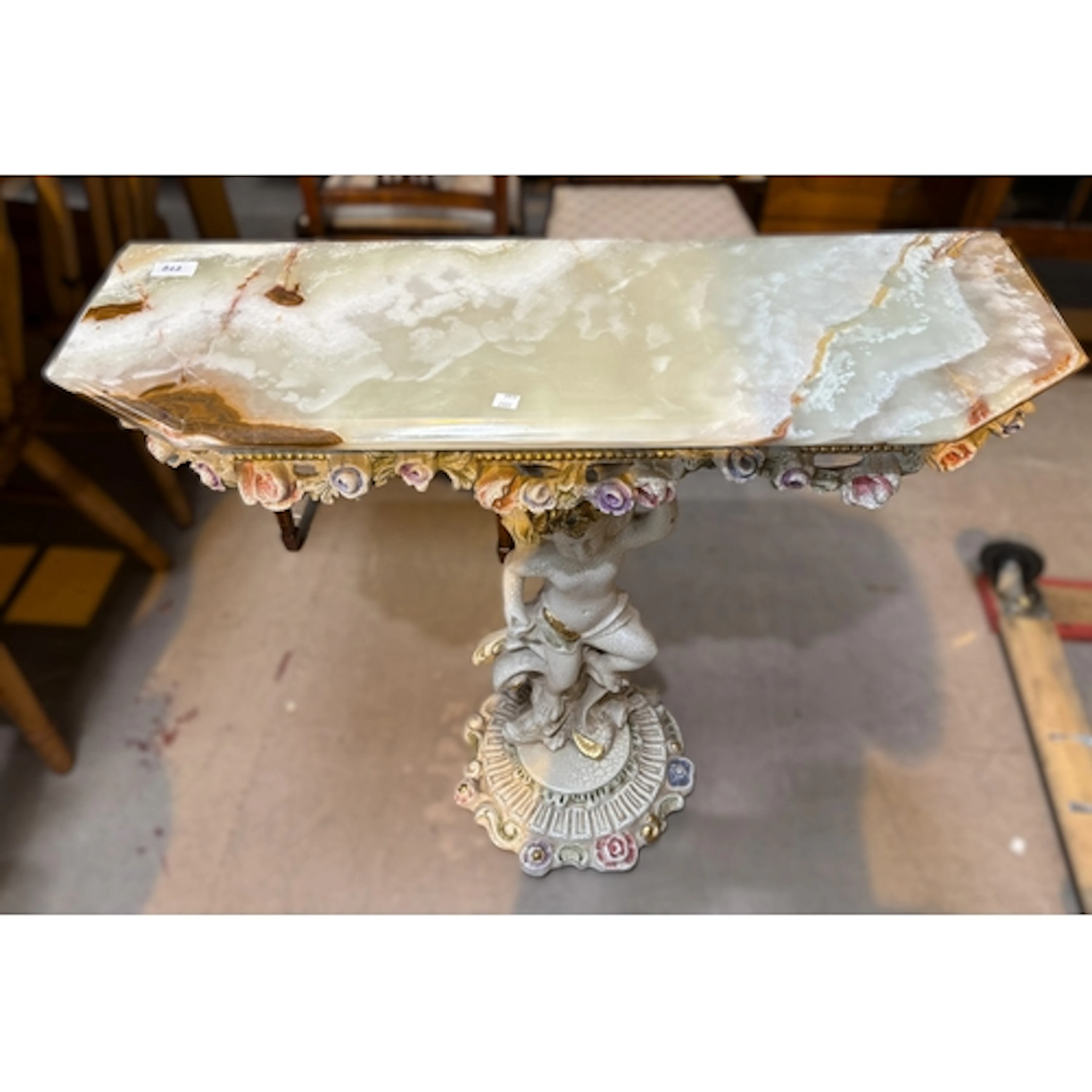 A pretty onyx top period style side table supported by cheru...
