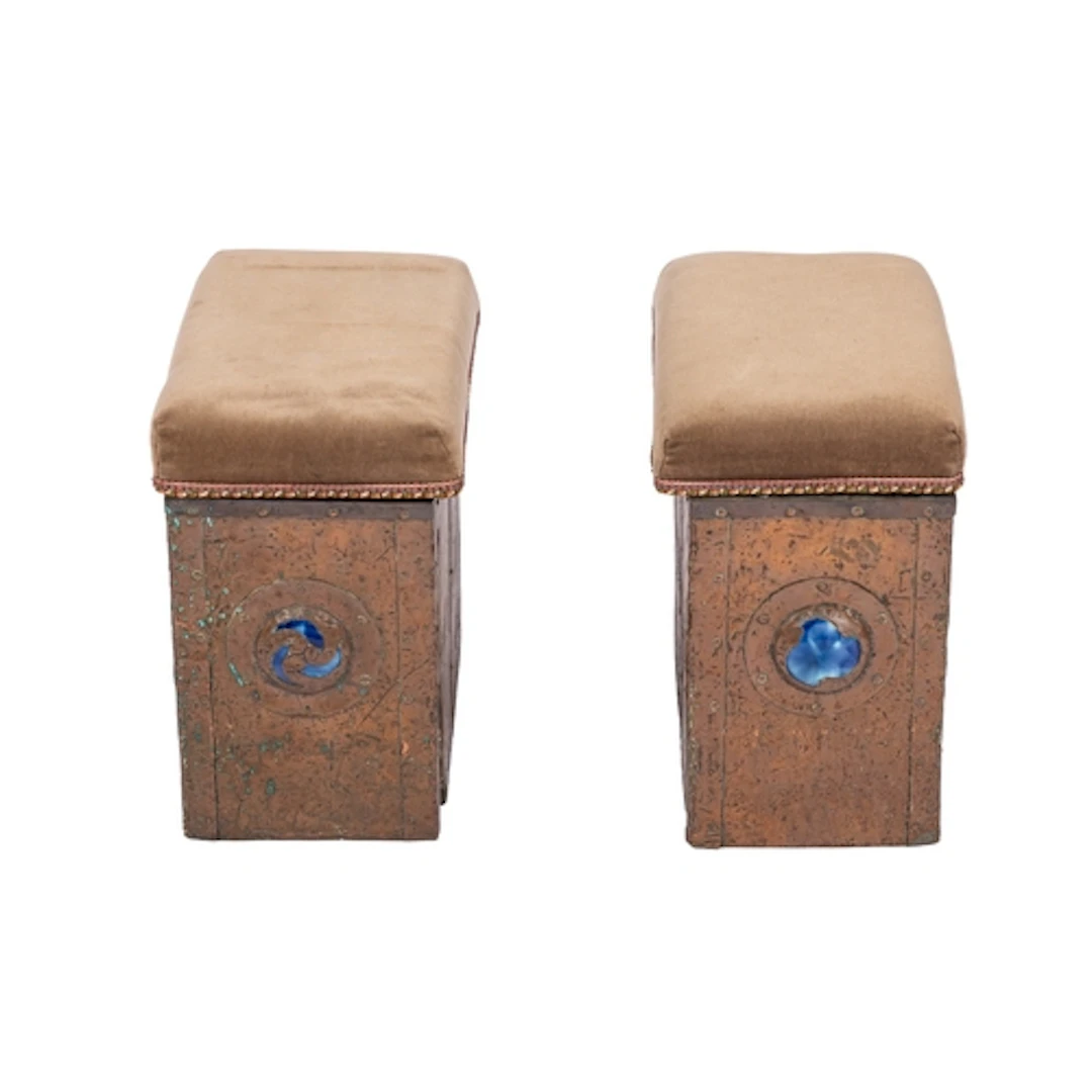 A pair of Arts and Crafts beaten copper and enamelled fender...