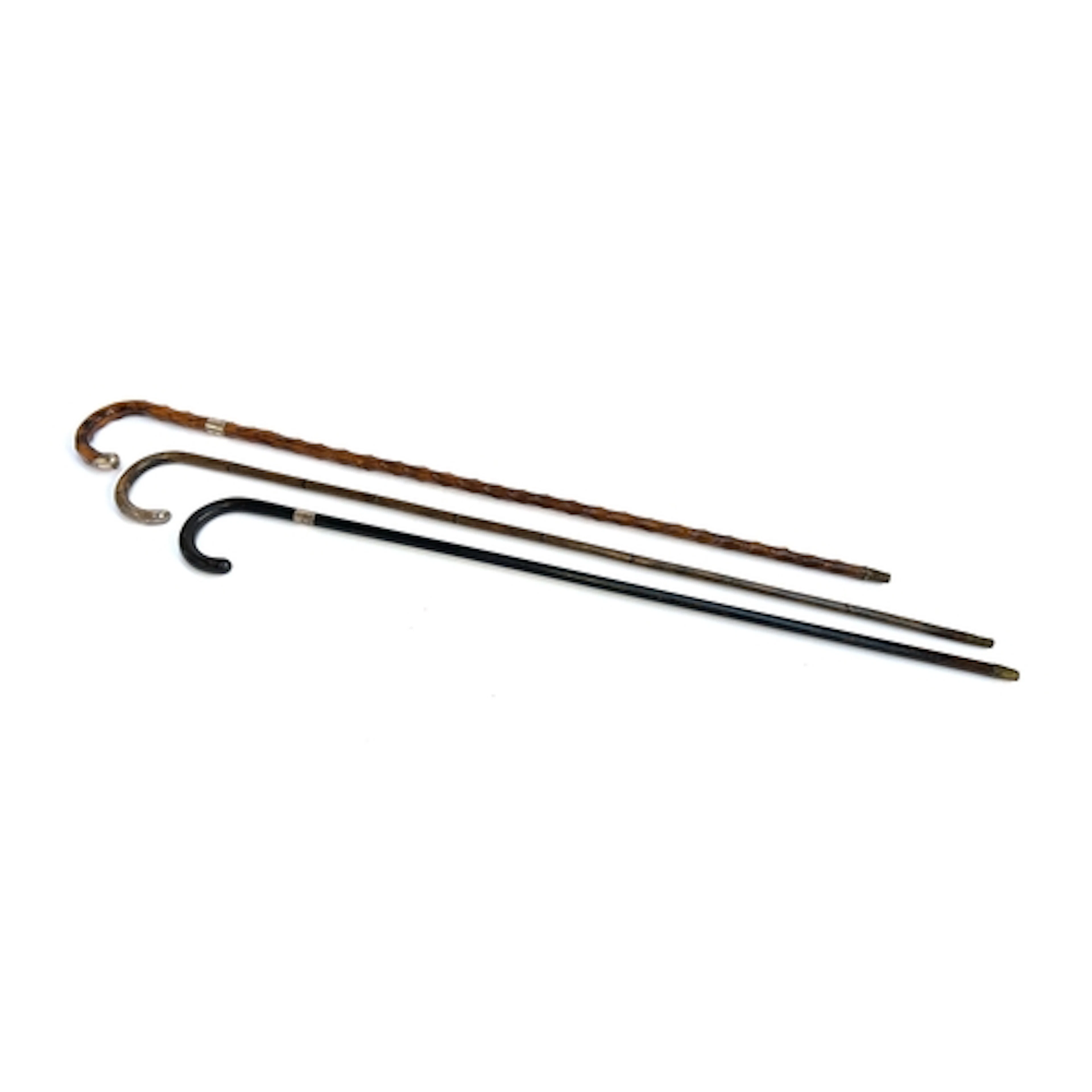 Three 19th century walking sticks, one ebonised, one bamboo ...