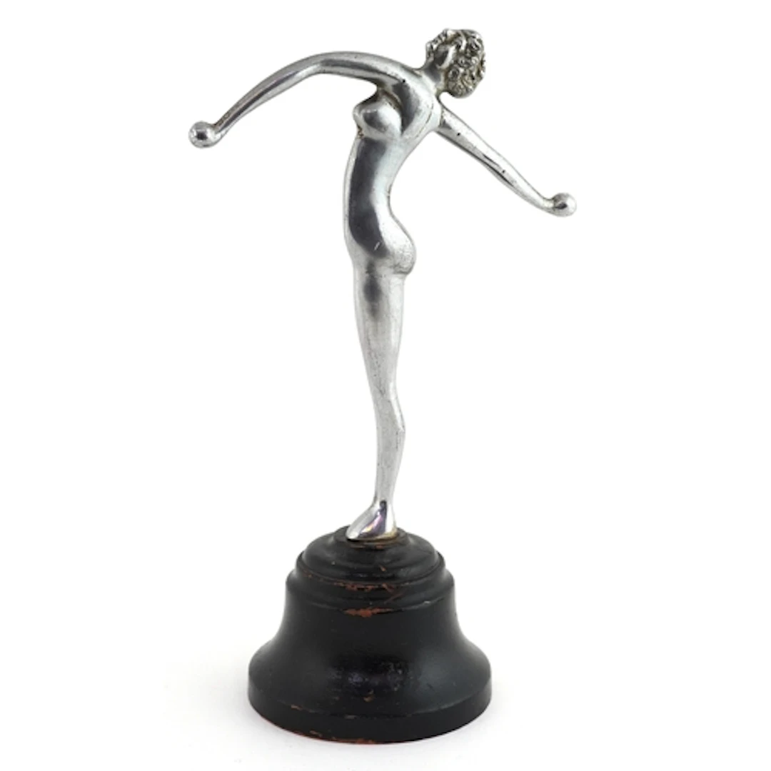 Chrome Art Deco figure of a nude female with raised arms, ra...
