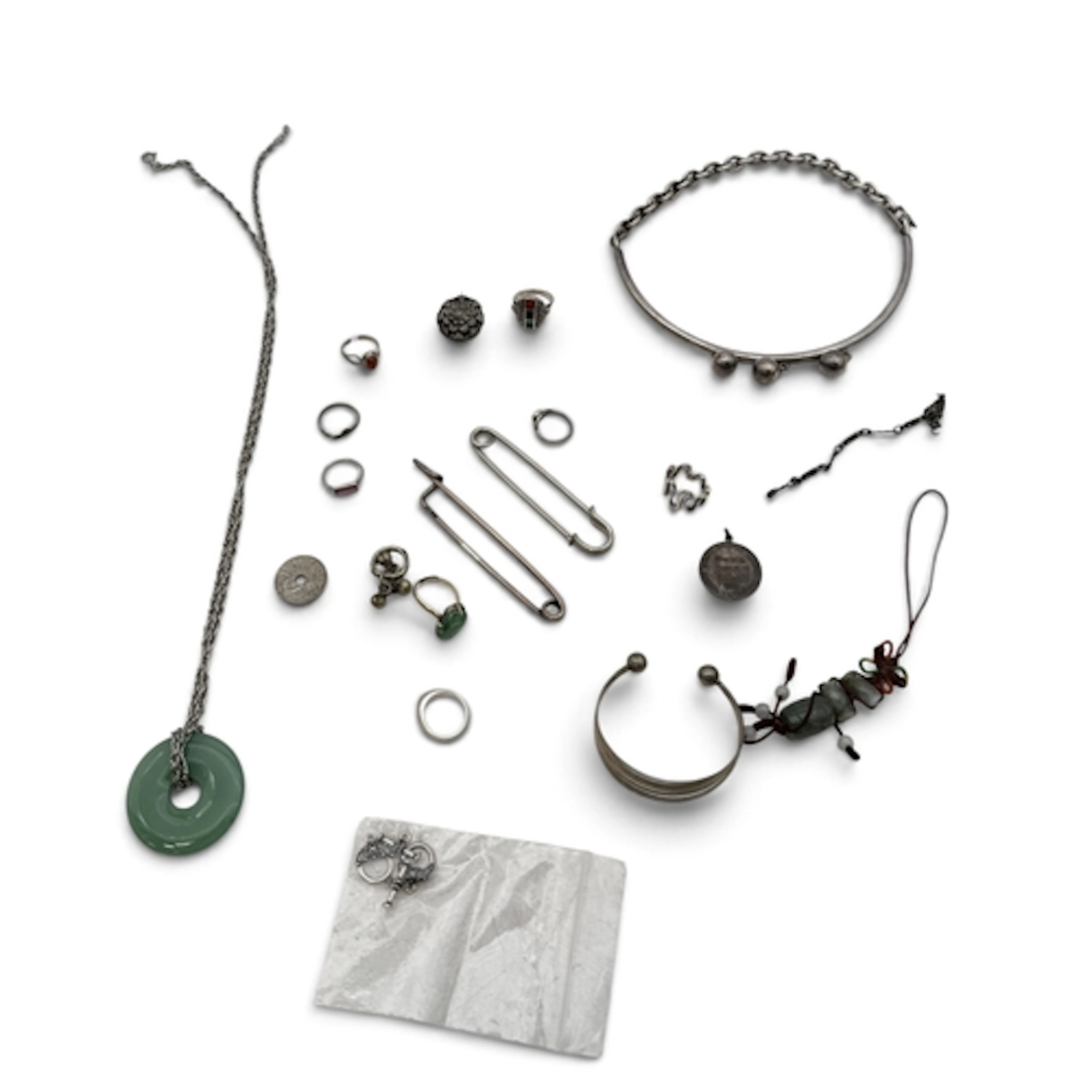 A BOX OF SILVER AND JADE JEWELLERY Together with silver coin...
