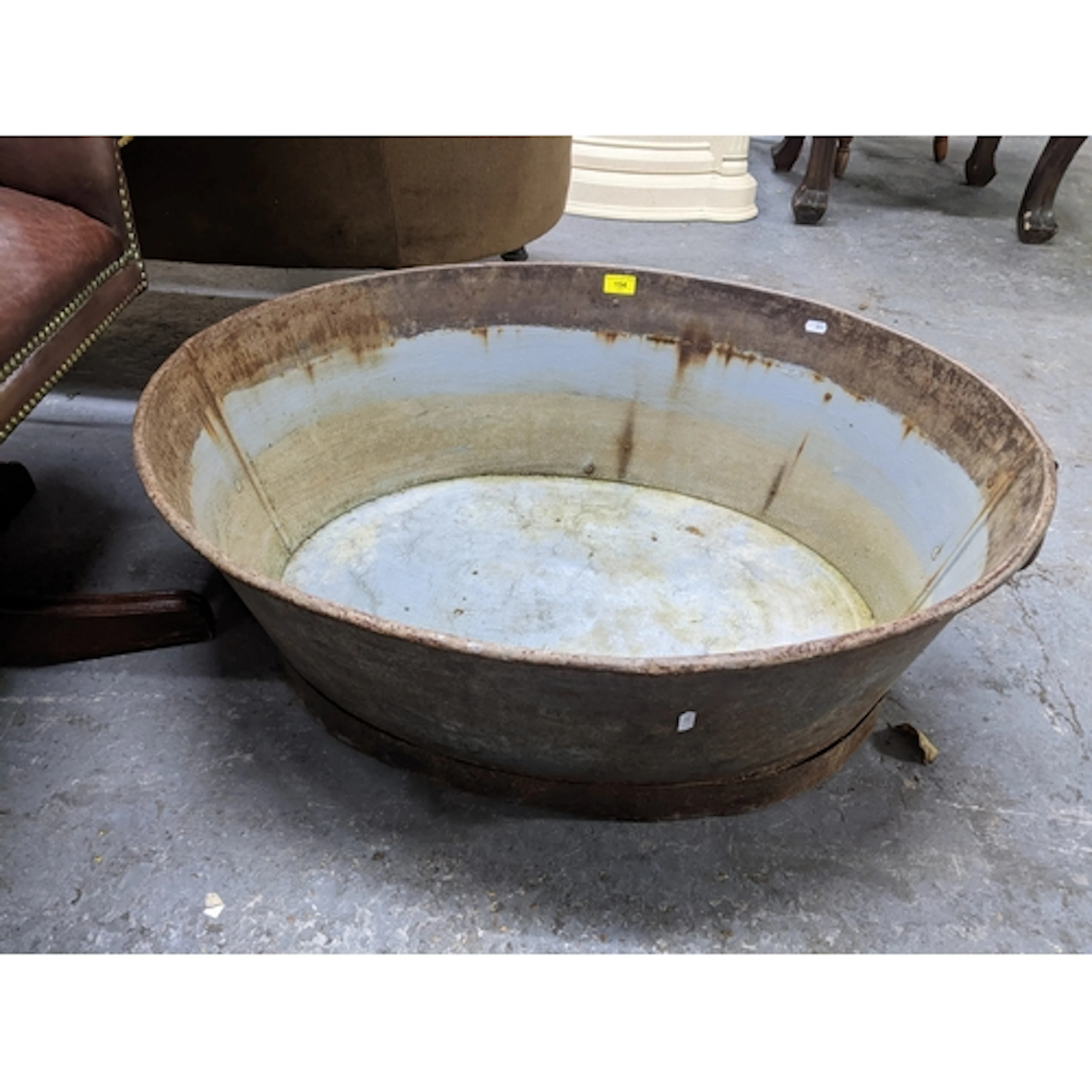 A vintage oval galvanised tin bath/planter with twin ring ca...