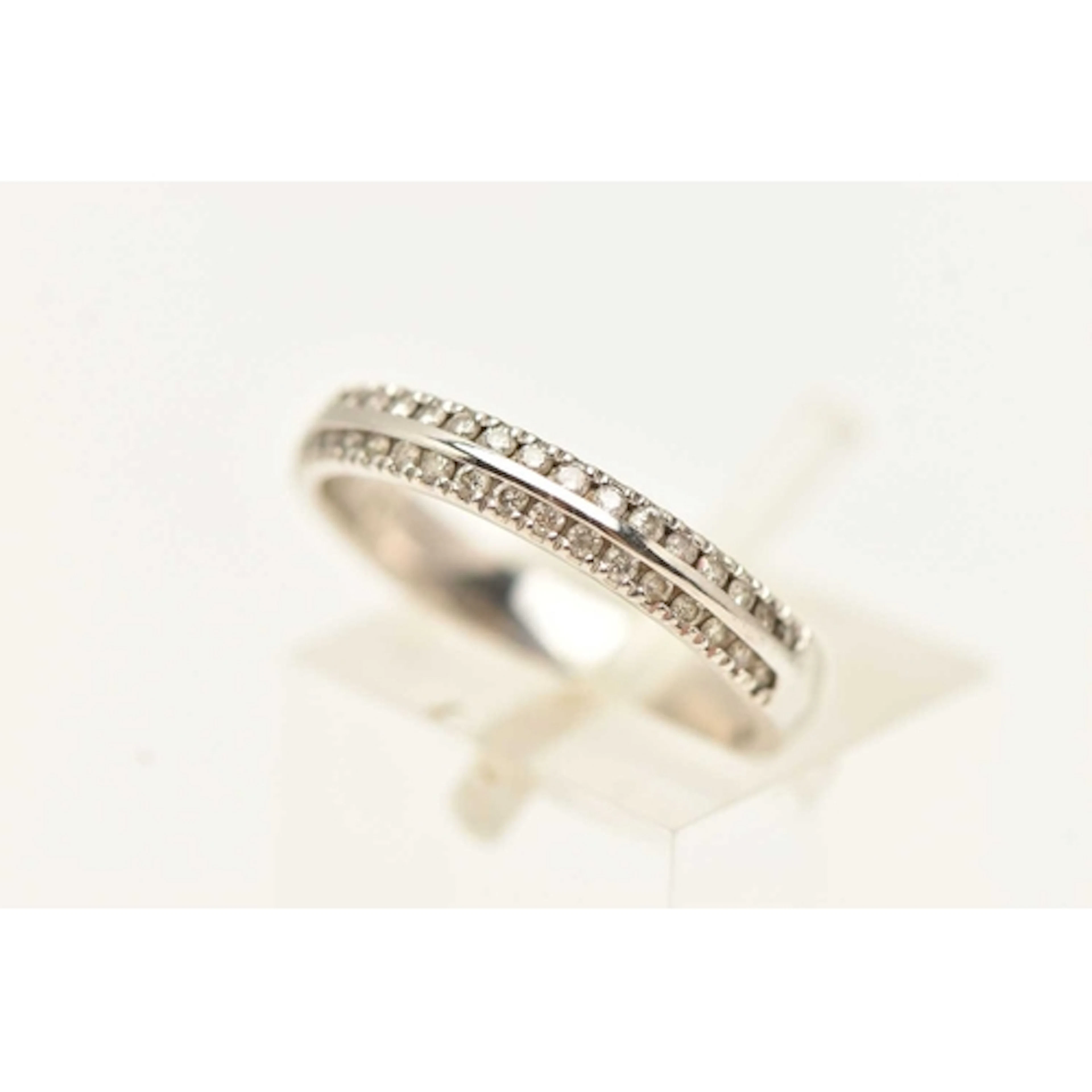AN 18CT WHITE GOLD BAND RING, half set with a double row of ...