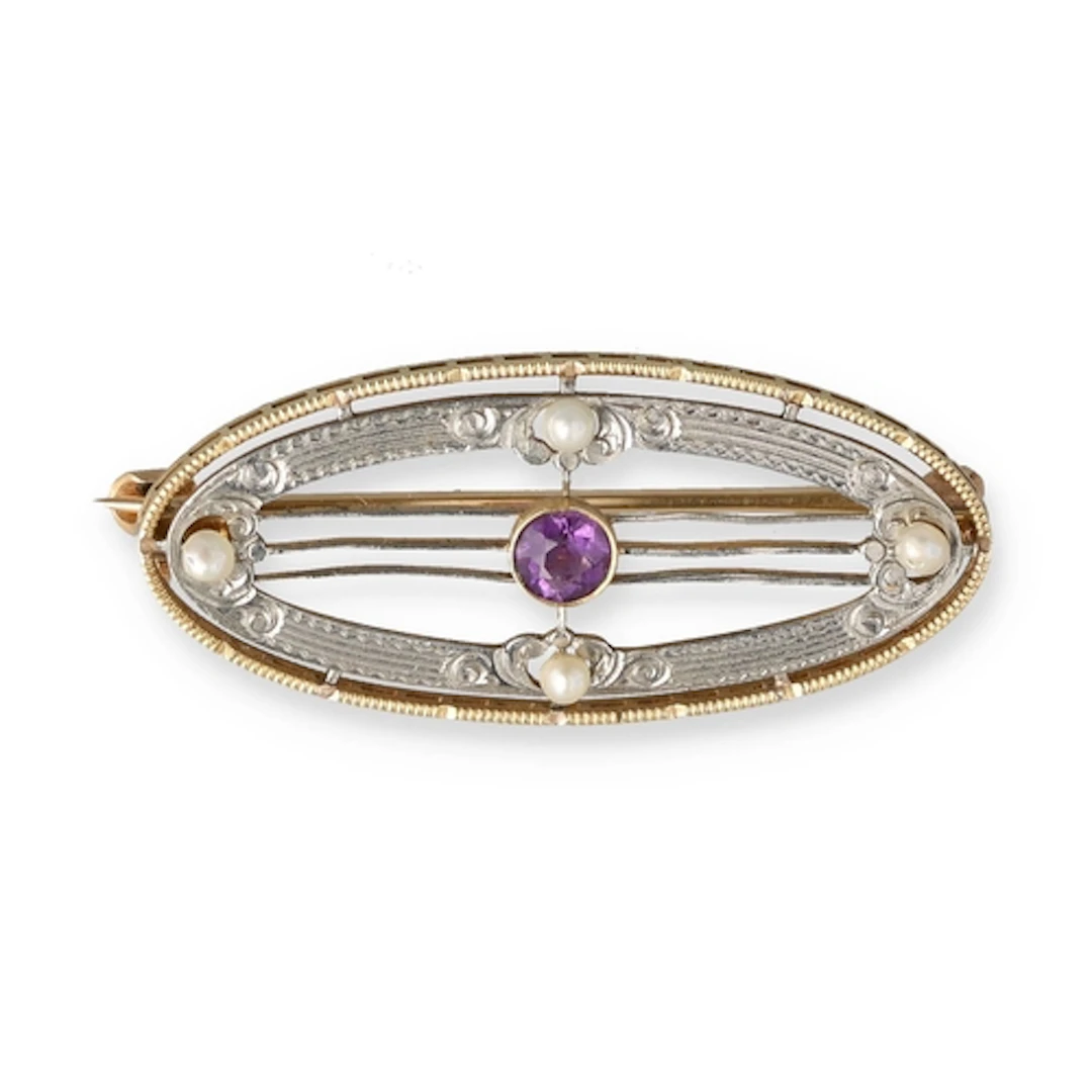 A MAPPIN AND WEBB 14CT GOLD AND SILVER BROOCH Set with ameth...