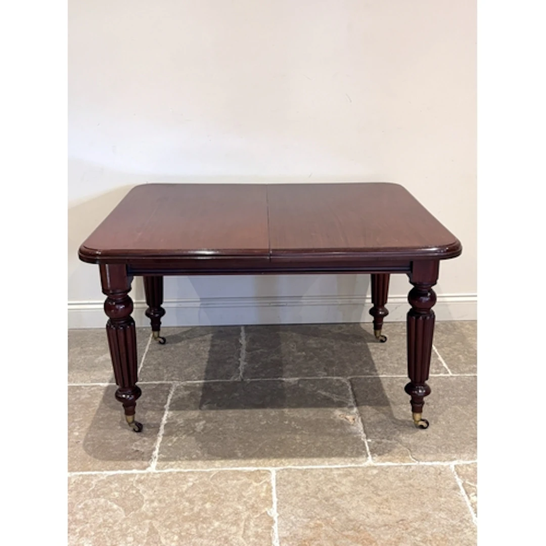 A Victorian mahogany dinning table, the rounded rectangular ...