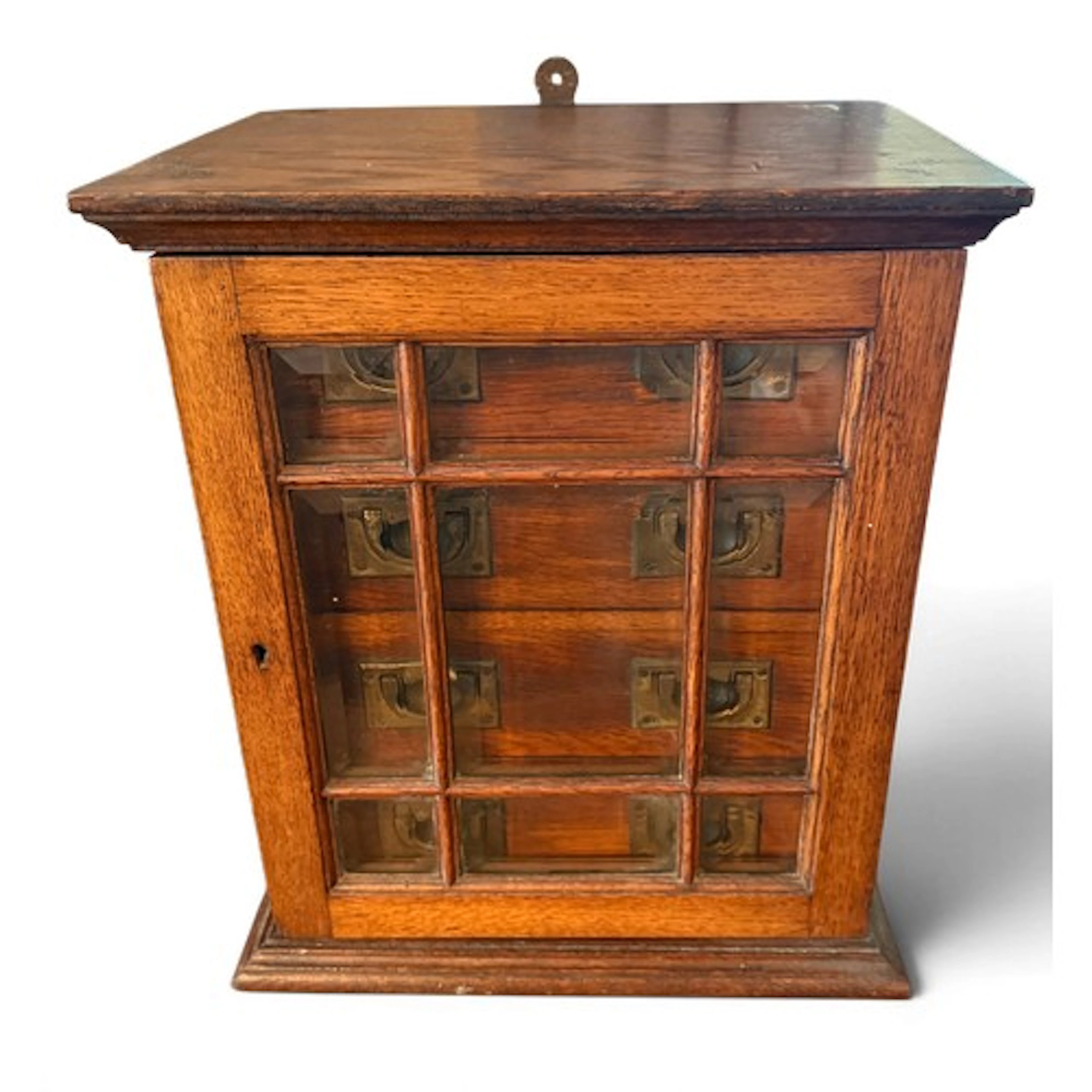 An Edwardian oak 4 drawer cabinet with glazed front.