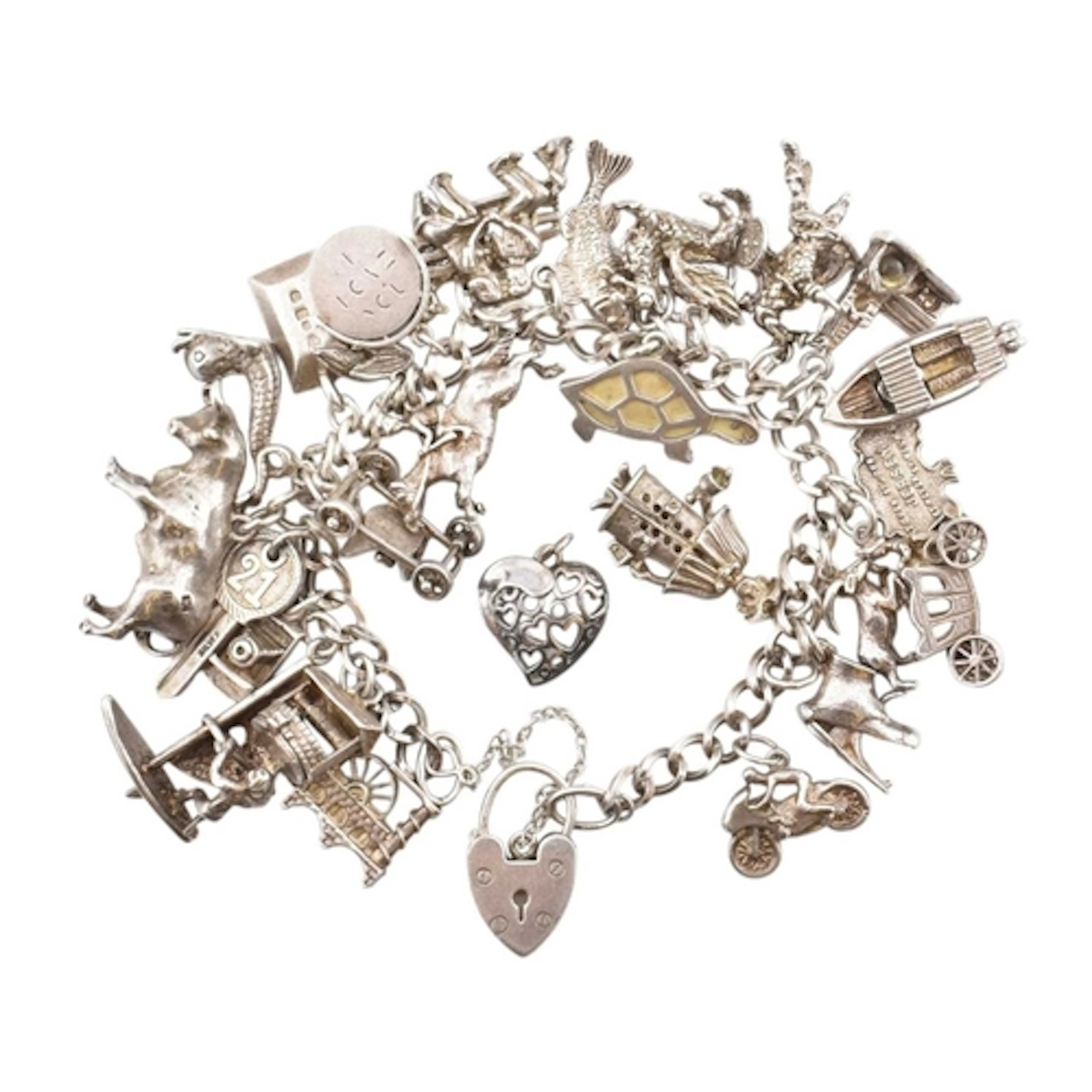 A 1970s hallmarked silver and white metal charm bracelet and...
