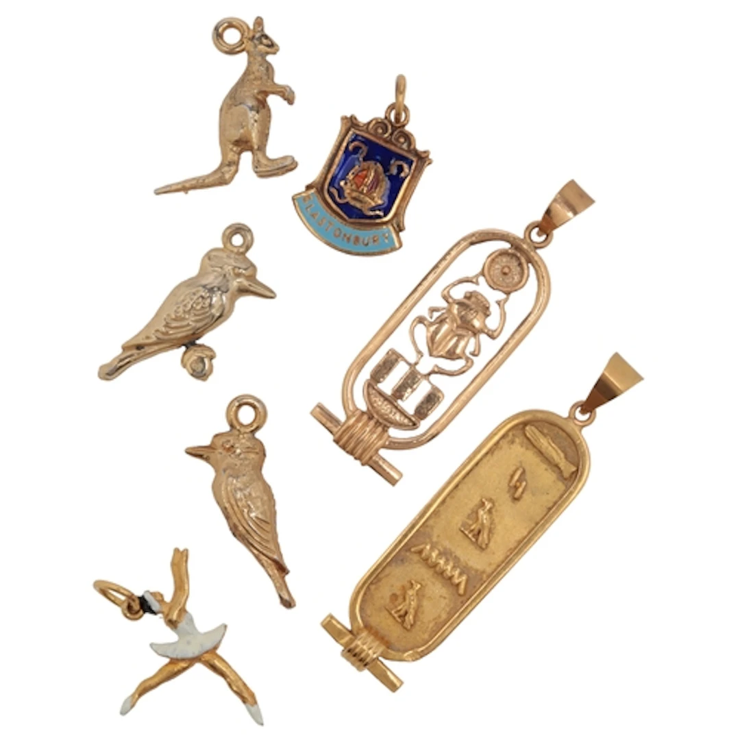 A collection of seven charms, comprising: two charms designe...