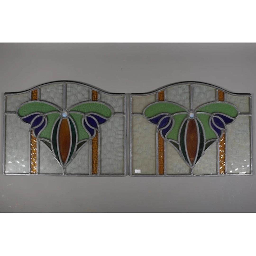 Pair of arched lead lined stained glass windows with bluebel...