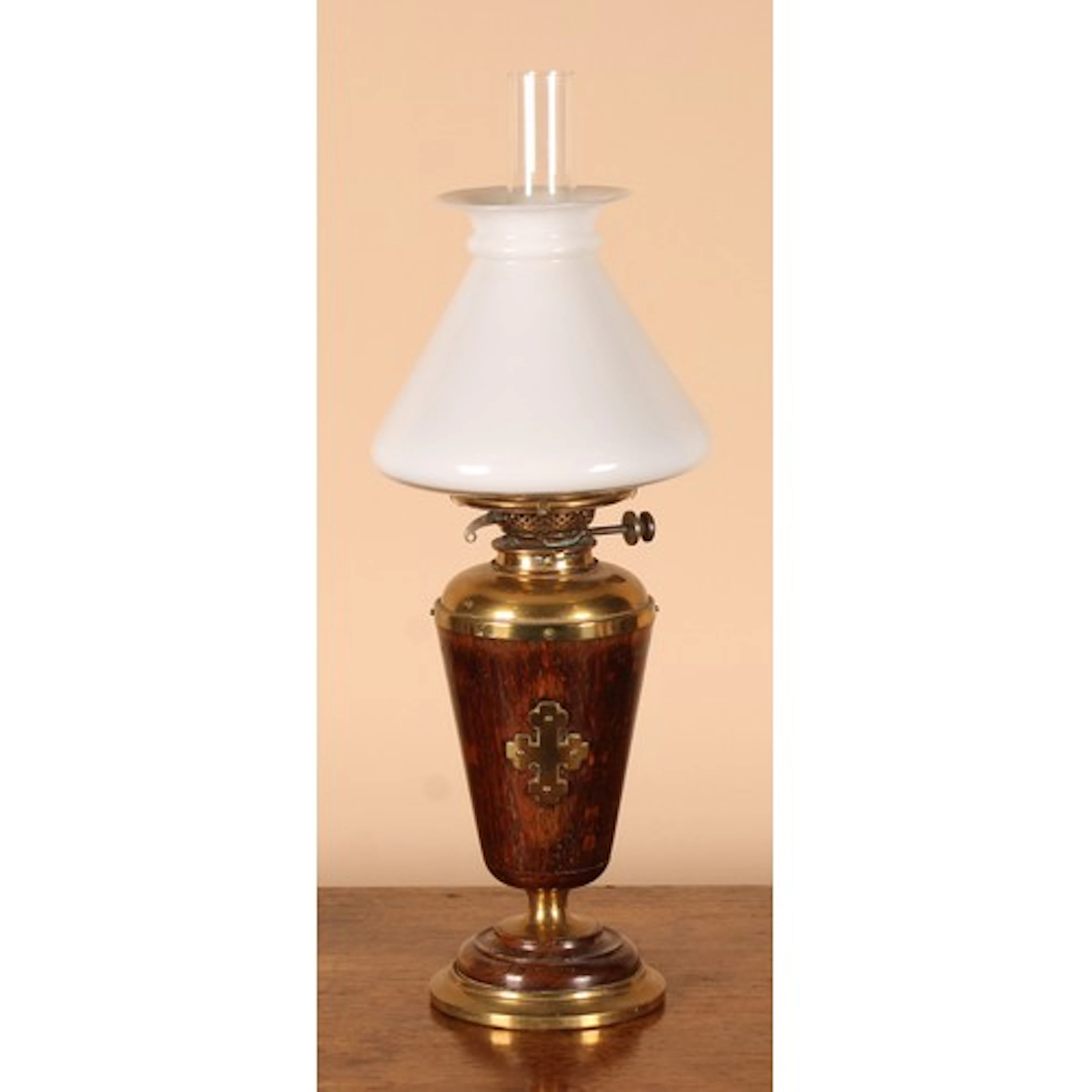 An Arts & Crafts oak and brass oil lamp, probably ecclesiast...