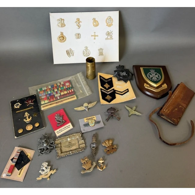 A selection of militaria, to include: cap badges, medal ribb...