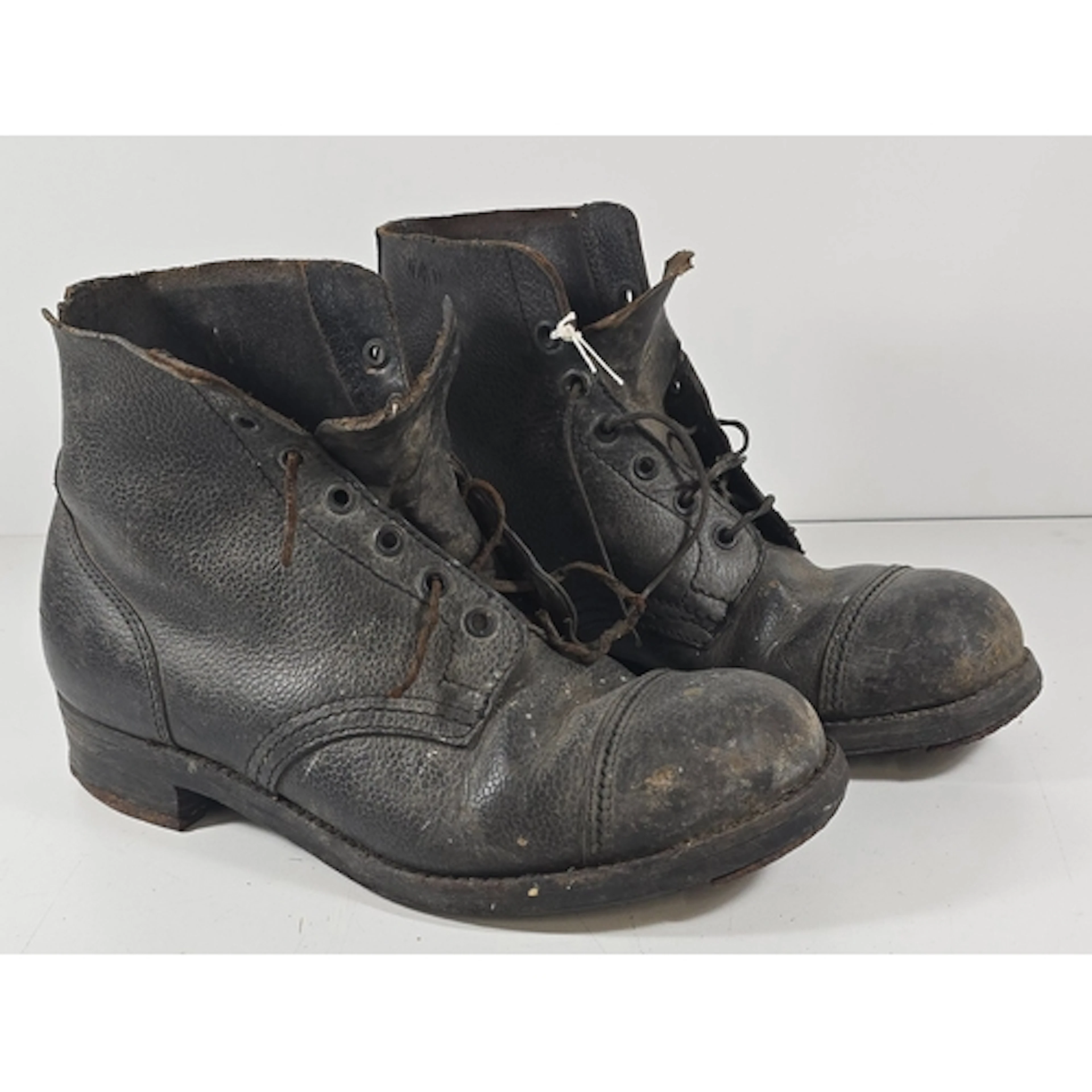 A pair of WWI army issue hob-nailed leather boots, stamped w...