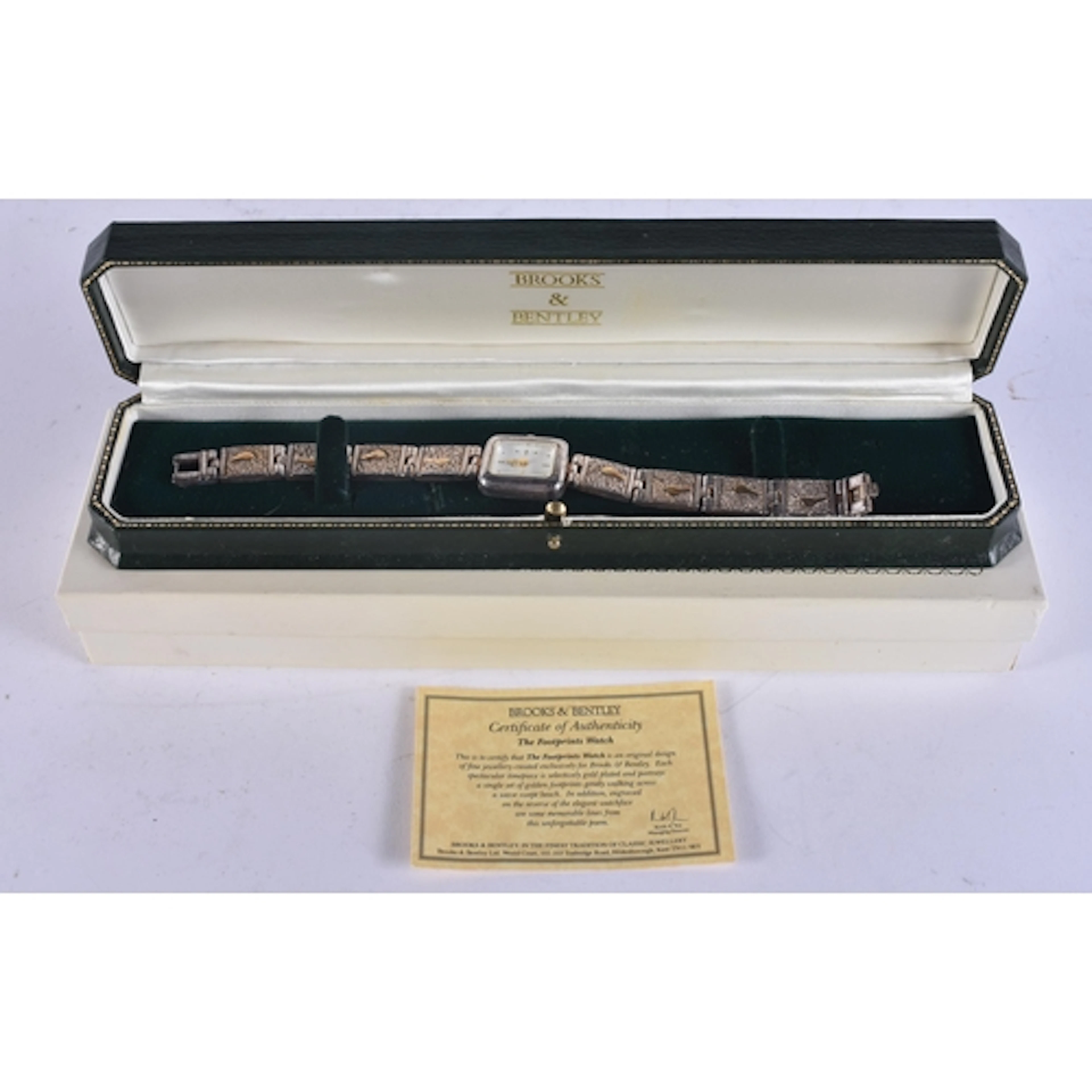 A SILVER BROOKS & BENTLEY FOOTPRINT WATCH. Untested. 2 cm wi...