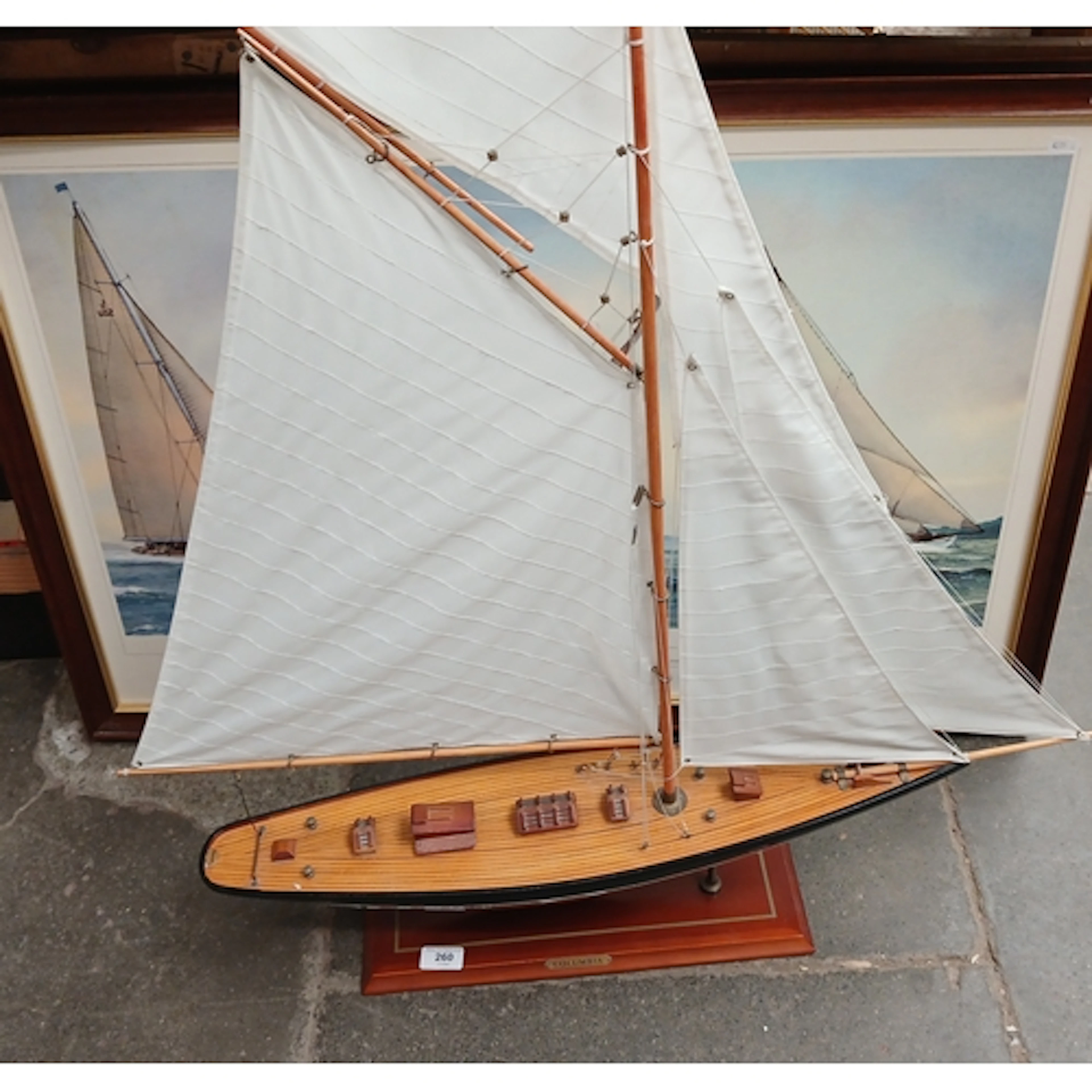 A model yacht and a print after Frank Gardiner.