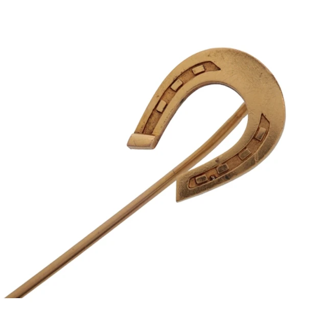 A gold stick pin, early 20th century, designed as a horsesho...