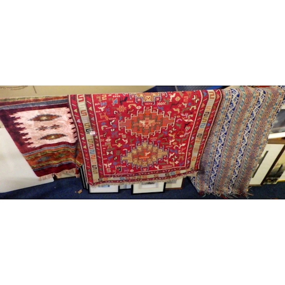 A tribal rug together with two further rugs (3)