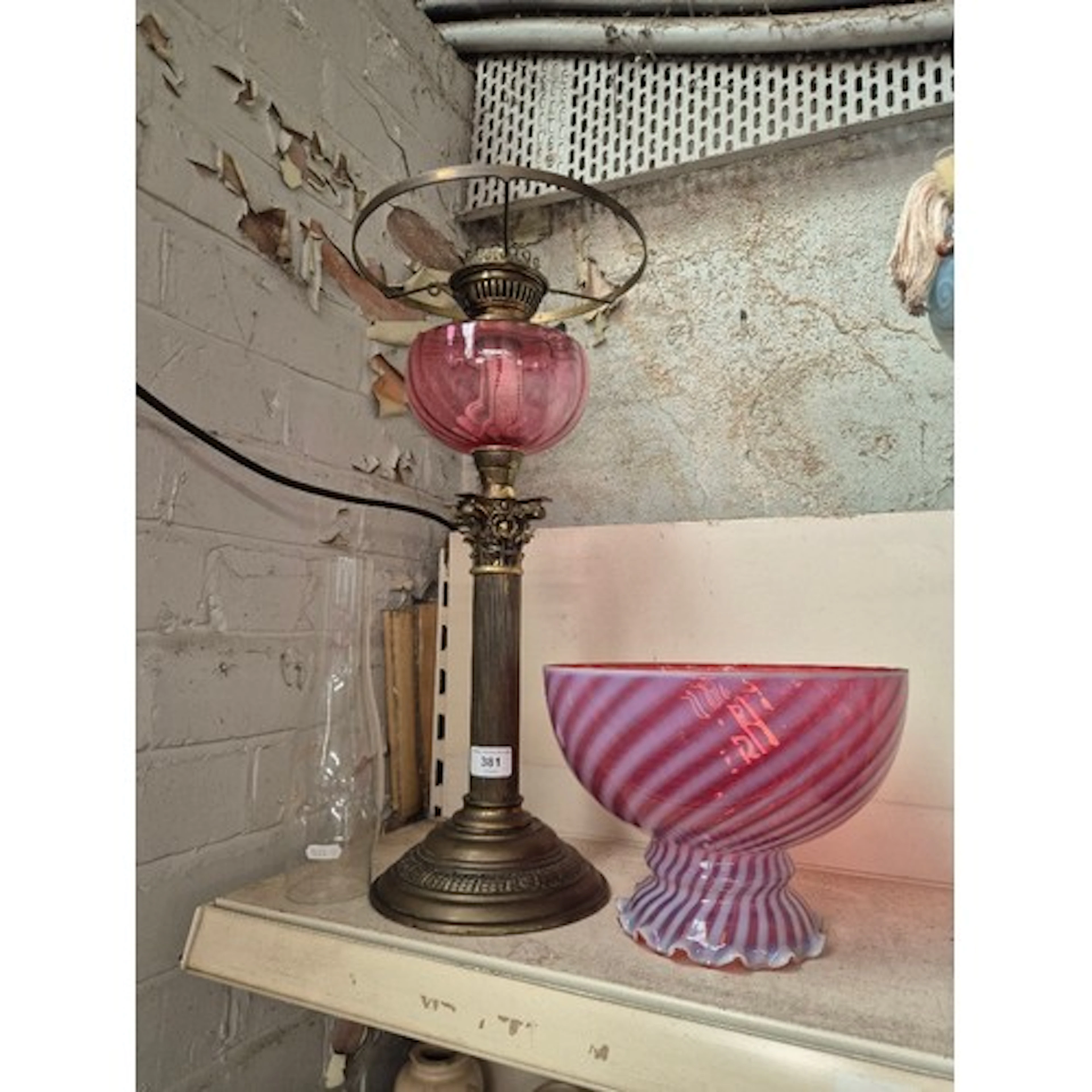 A Victorian brass Corinthian column oil lamp with cranberry ...