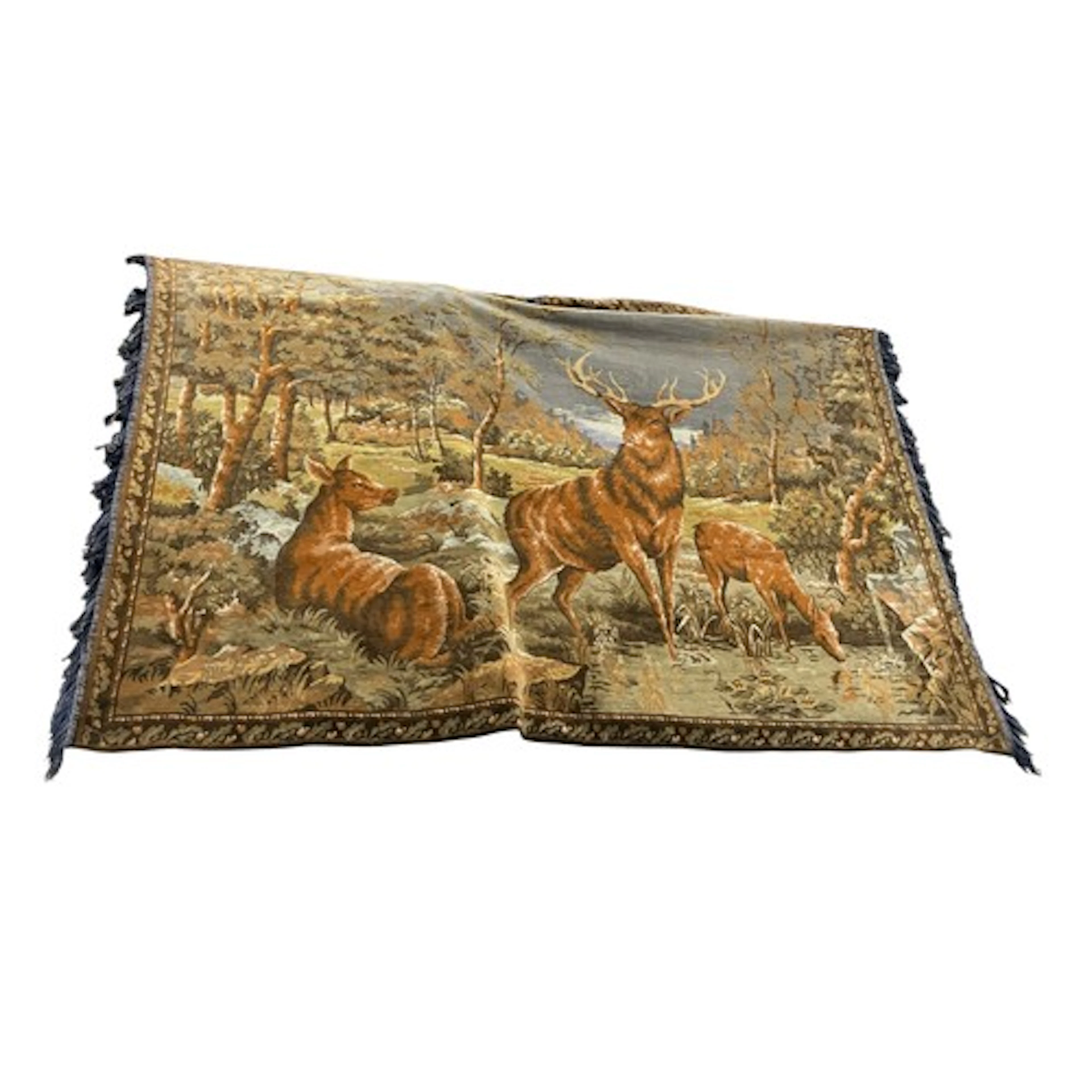 Wall-hanging tapestry depicting deer in a forest.