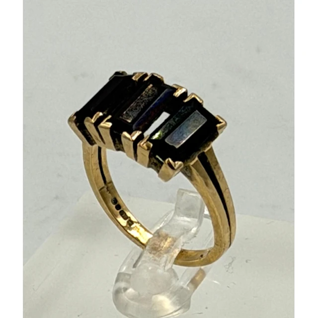A 9ct gold three stone garnet ring, approximate size N and w...