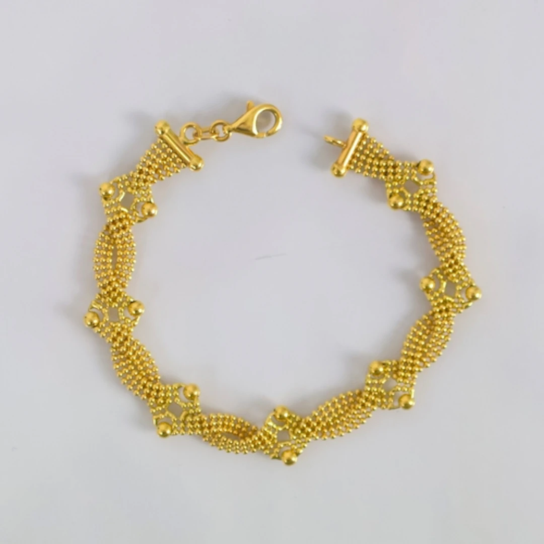 A contemporary Italian yellow metal bracelet, of beaded open...