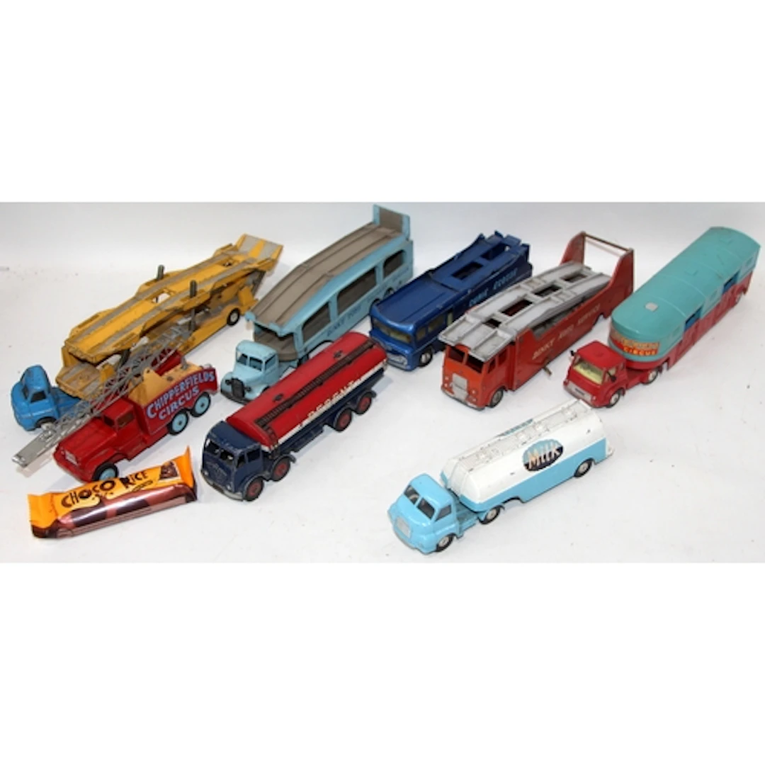 A collection of vintage play worn die-cast trucks and transp...