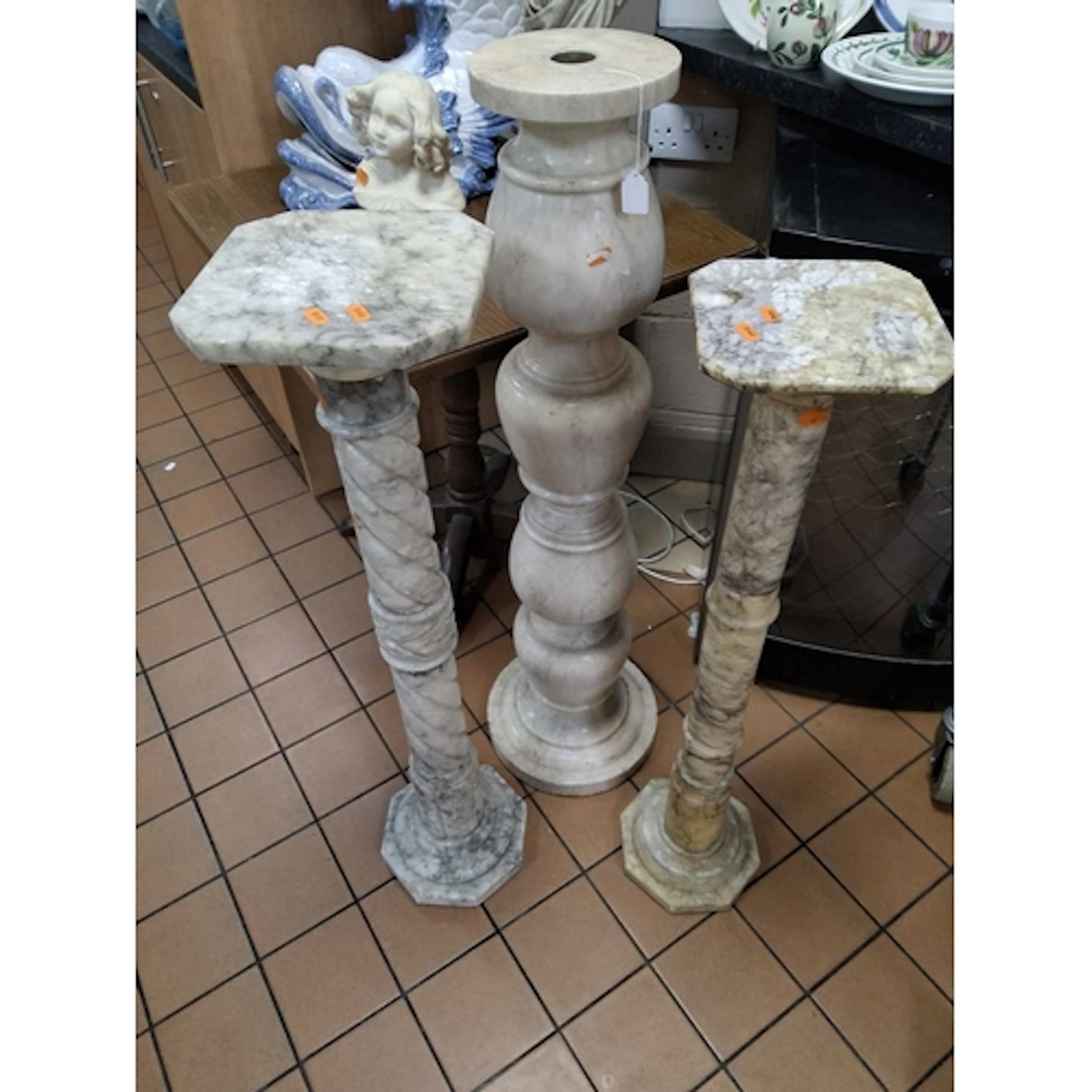 THREE VINTAGE STONE JARDINIERE STANDS comprising a tall marb...