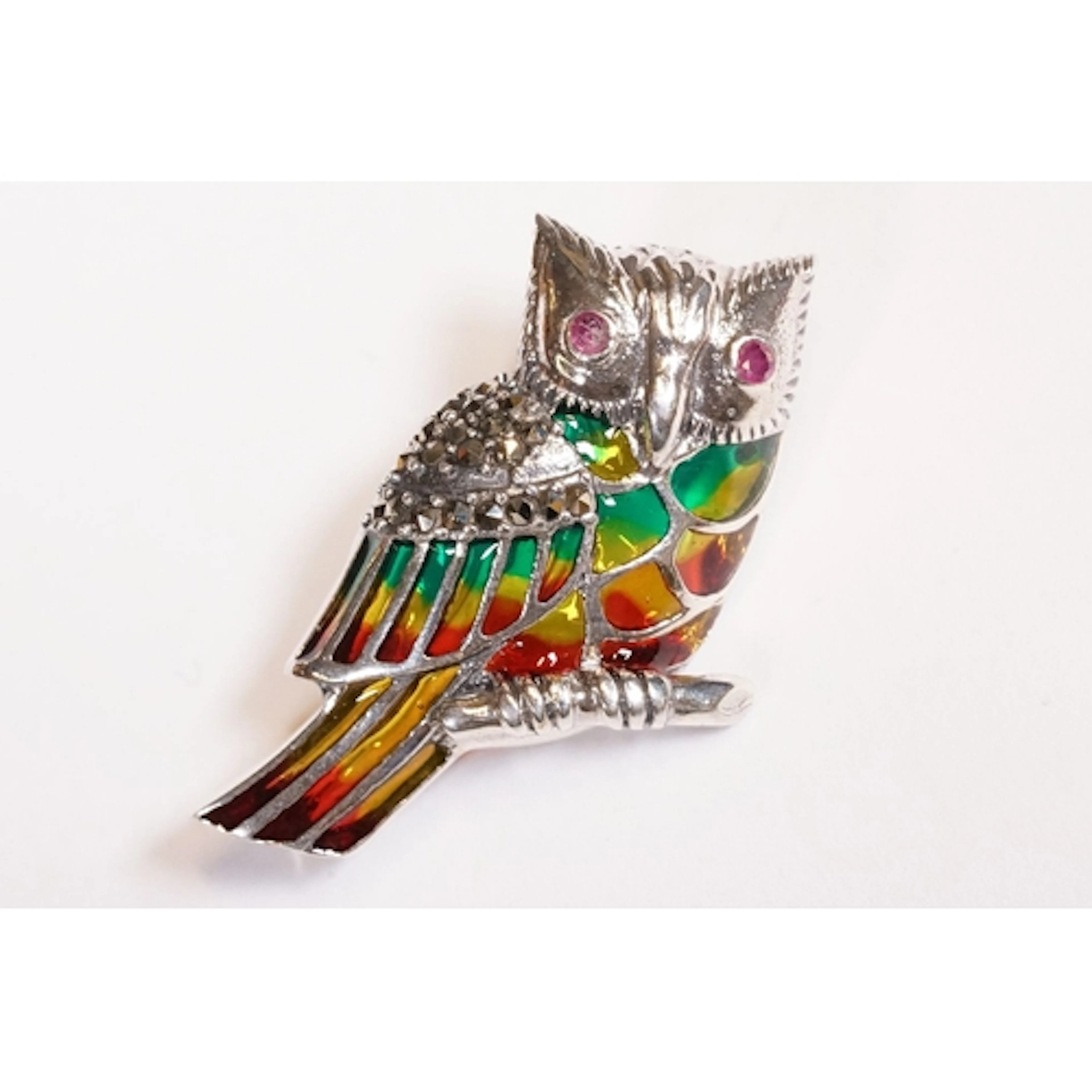 Silver plique a jour owl brooch with ruby eyes.
