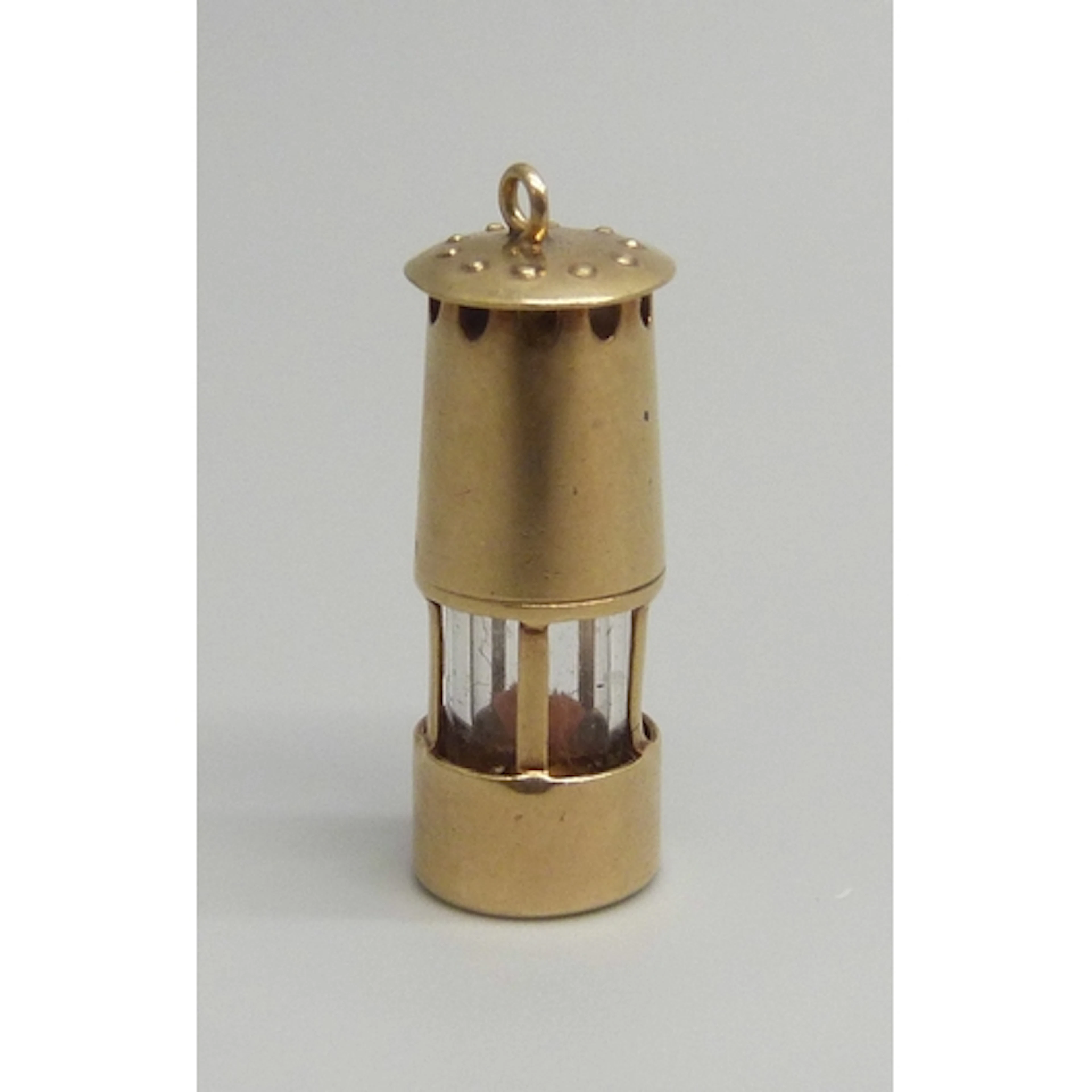 A 9ct gold charm in the form of a miner's lamp, hallmarked, ...