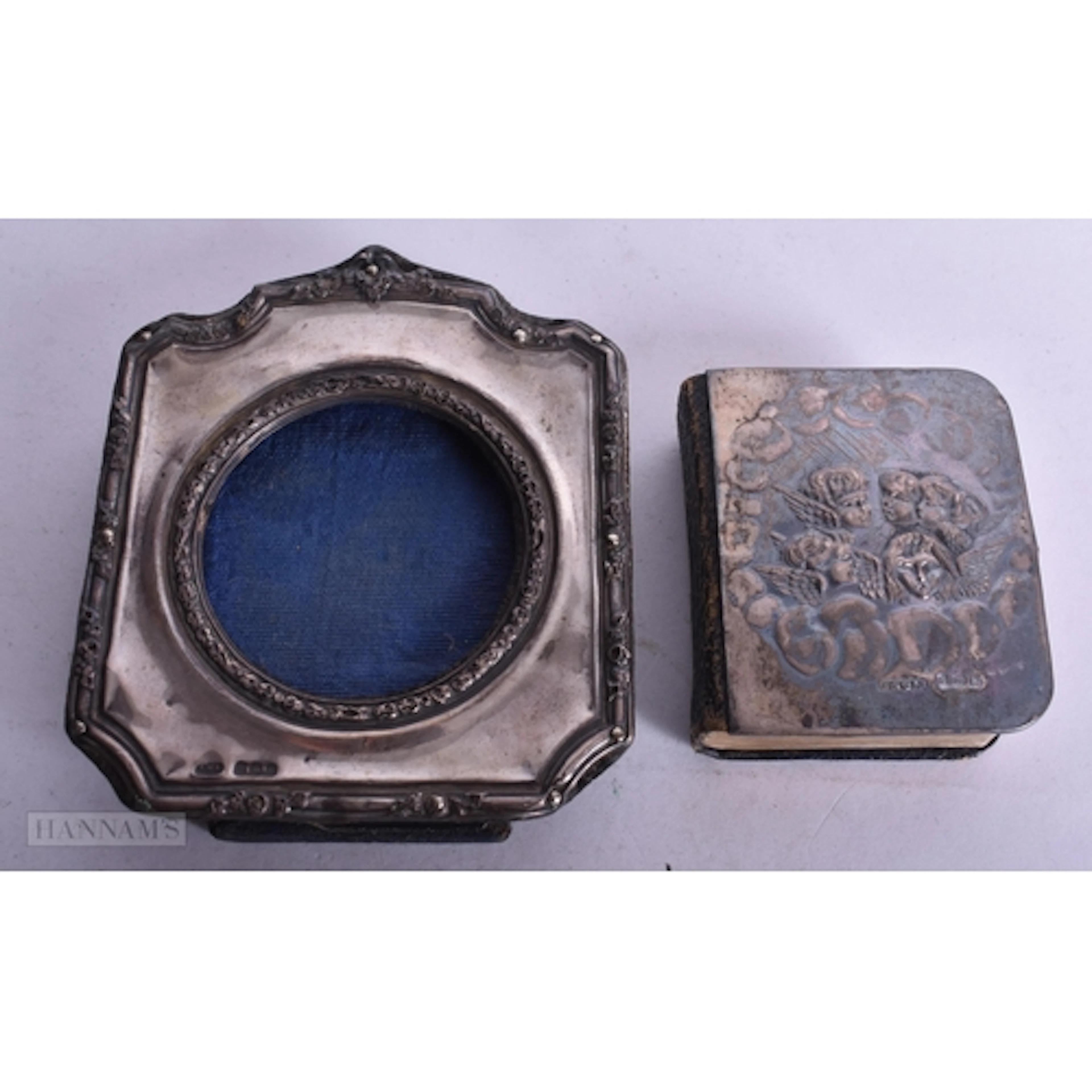 AN ANTIQUE SILVER MOUNTED BIBLE together with a silver frame...