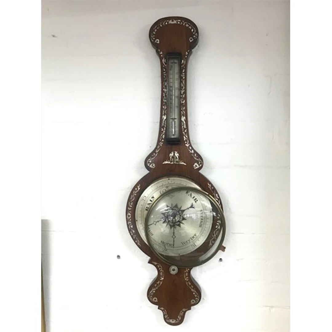 A Victorian rosewood inlaid barometer.