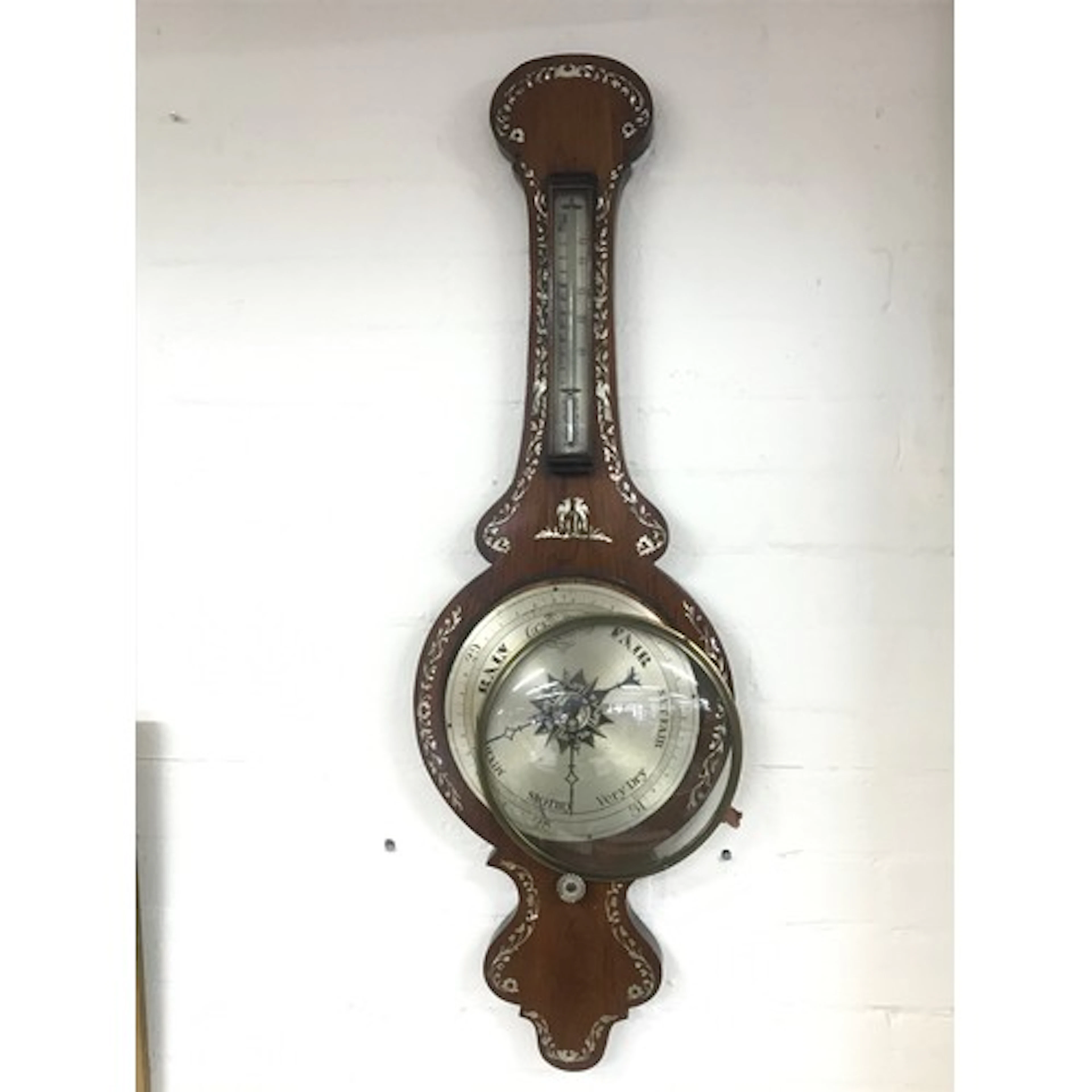 A Victorian rosewood inlaid barometer.
