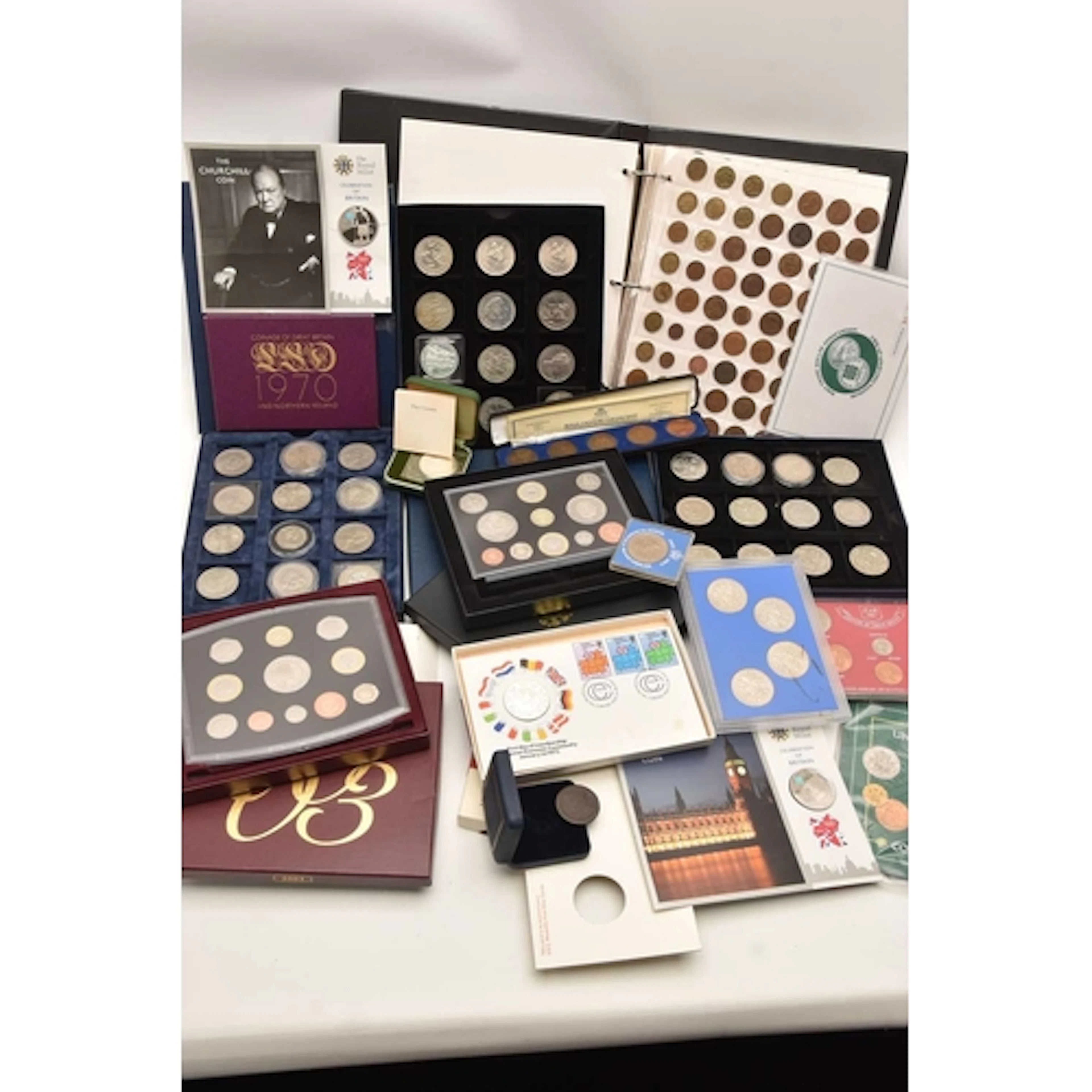 A box containing a coin album of 10 pages full of pre-decima...