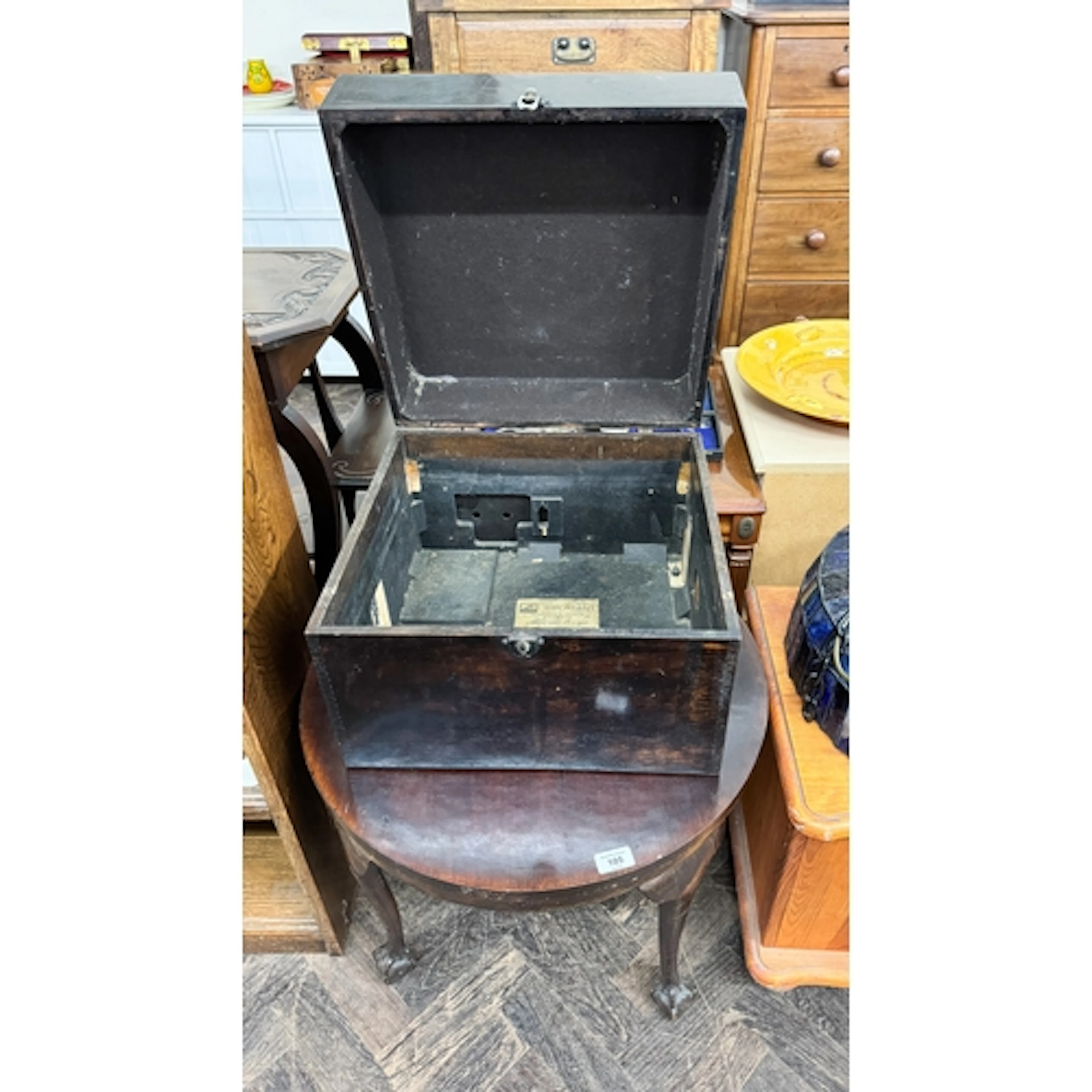 A circular mahogany coffee table on claw and ball feet and a...