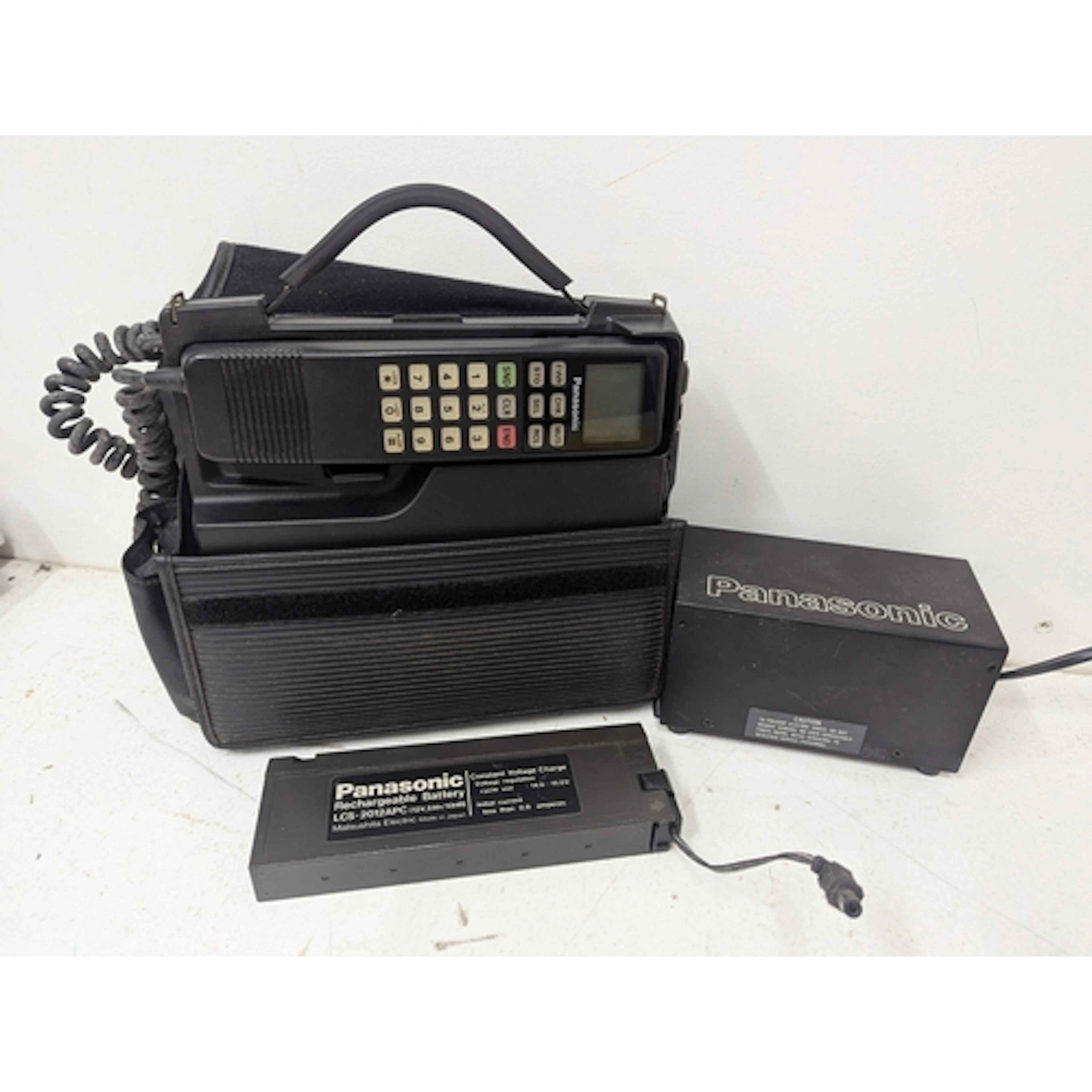 A Panasonic 1980s vintage mobile phone with charger and rech...