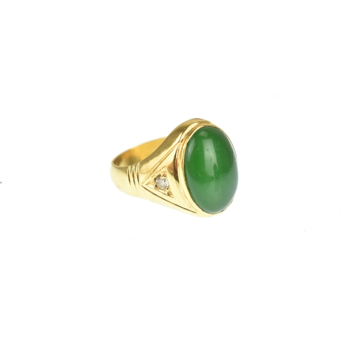 A yellow metal diamond and jade signet ring with a bezel set...