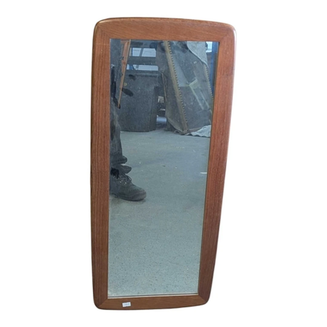 A mid 20th century circa 1960s teak wall mirror. The mirror ...
