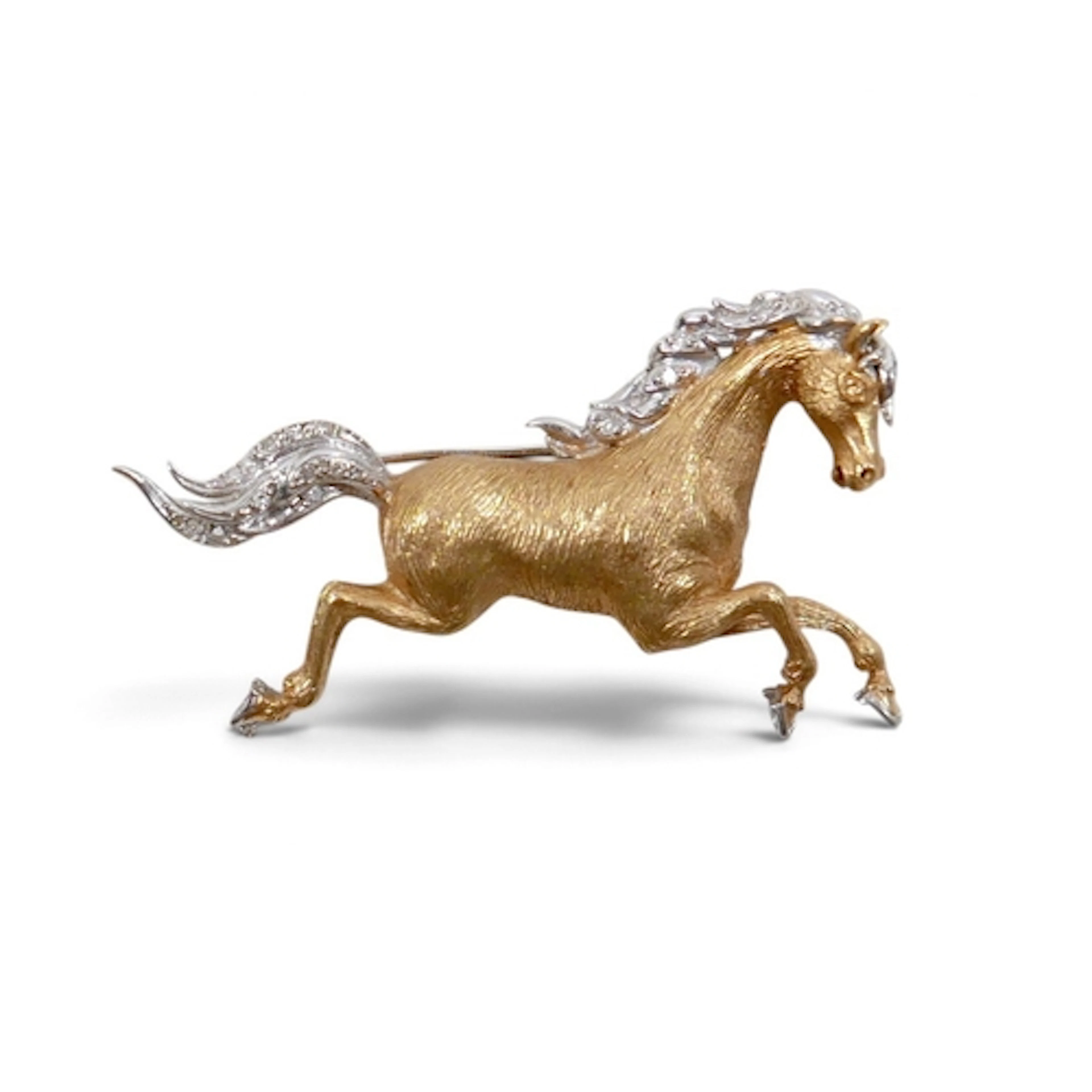 AN 18CT YELLOW & WHITE GOLD BROOCH. modelled as a running ho...