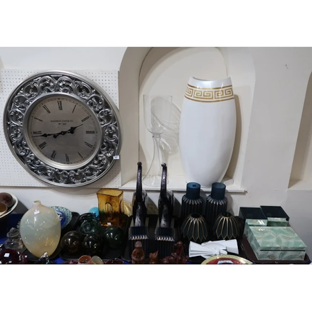 A large decorative wall clock, a large vase with Greek key d...