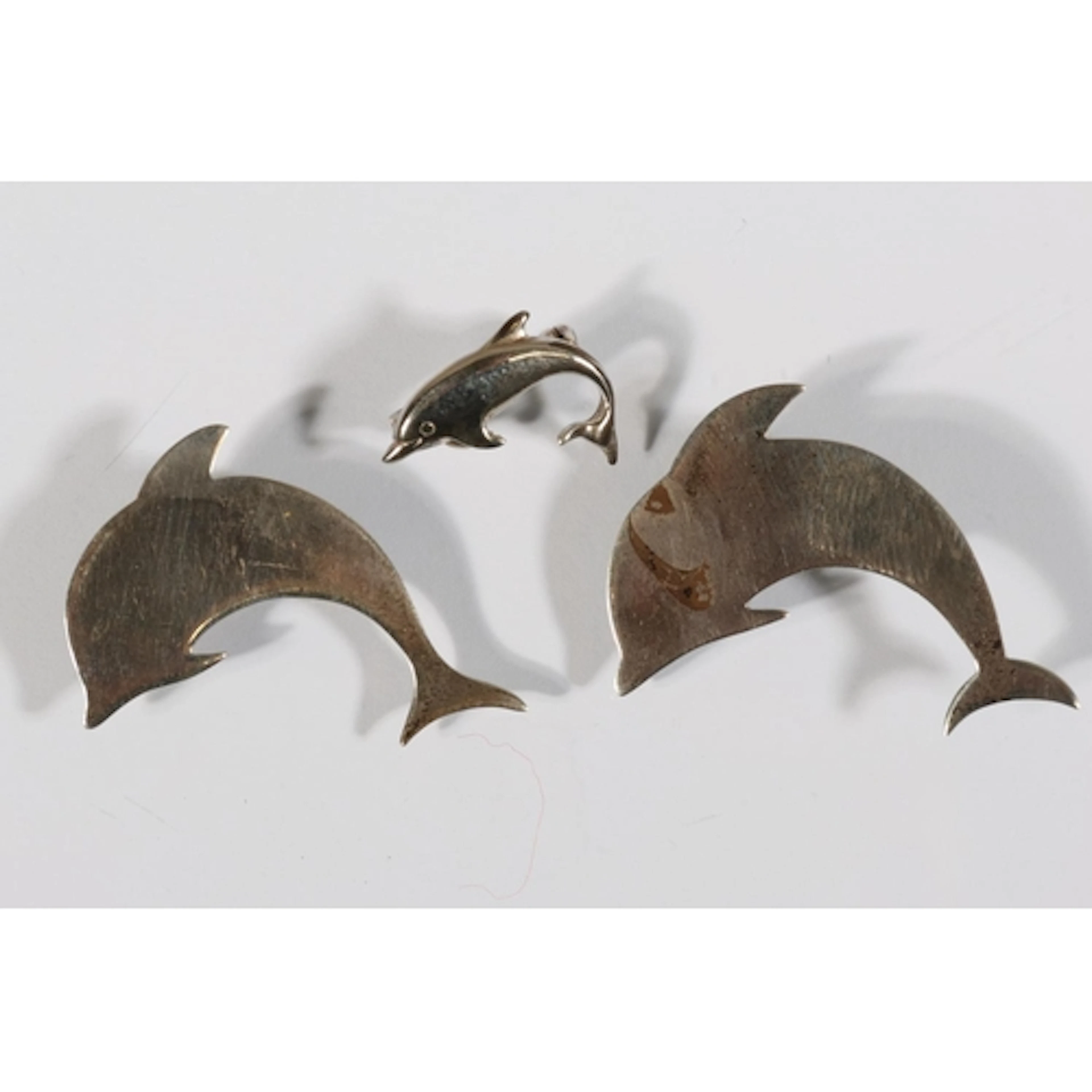 Two Modernist silver dolphin brooches, makers mark 'SW', hal...