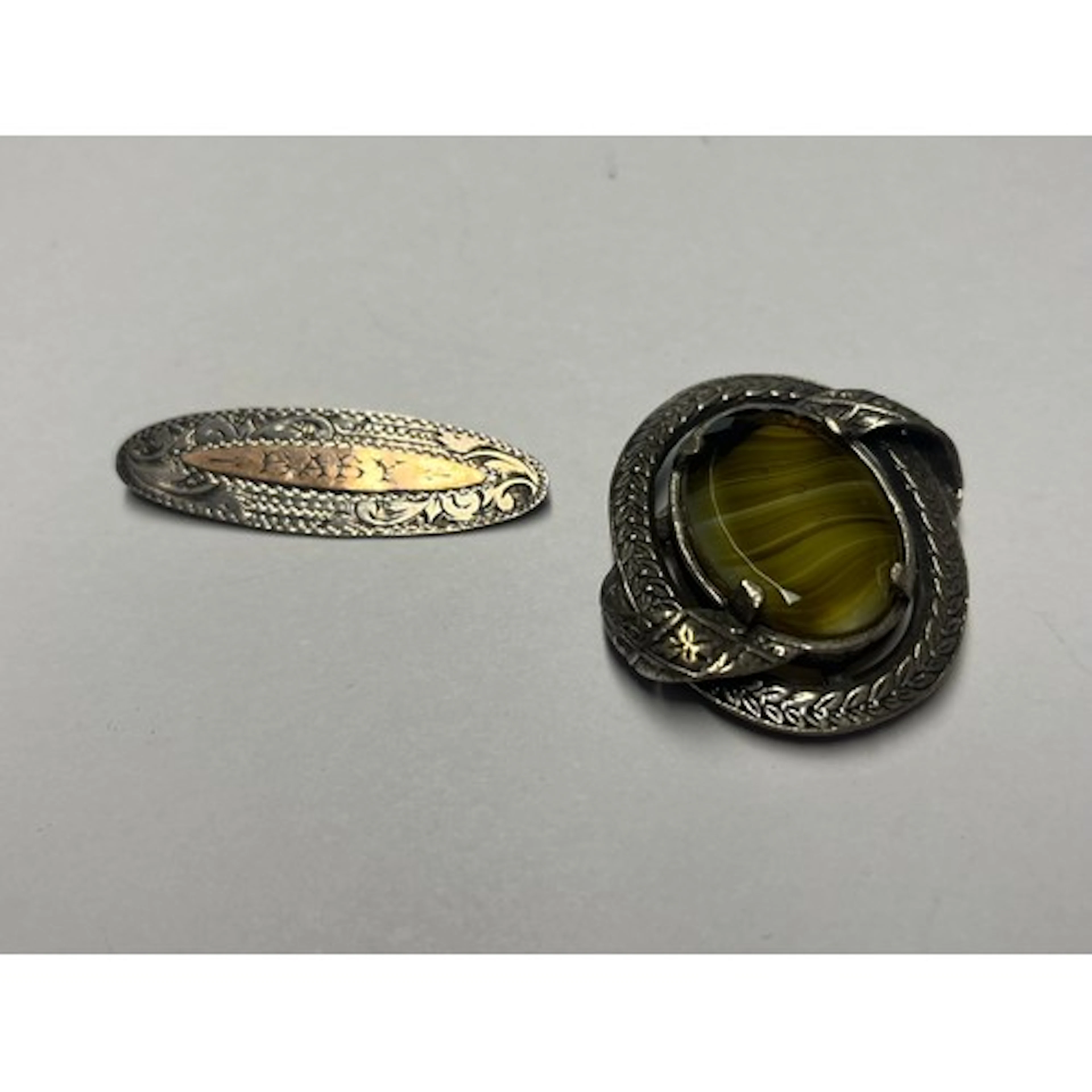 Silver engraved baby pin and a white metal and Cairngorn sto...