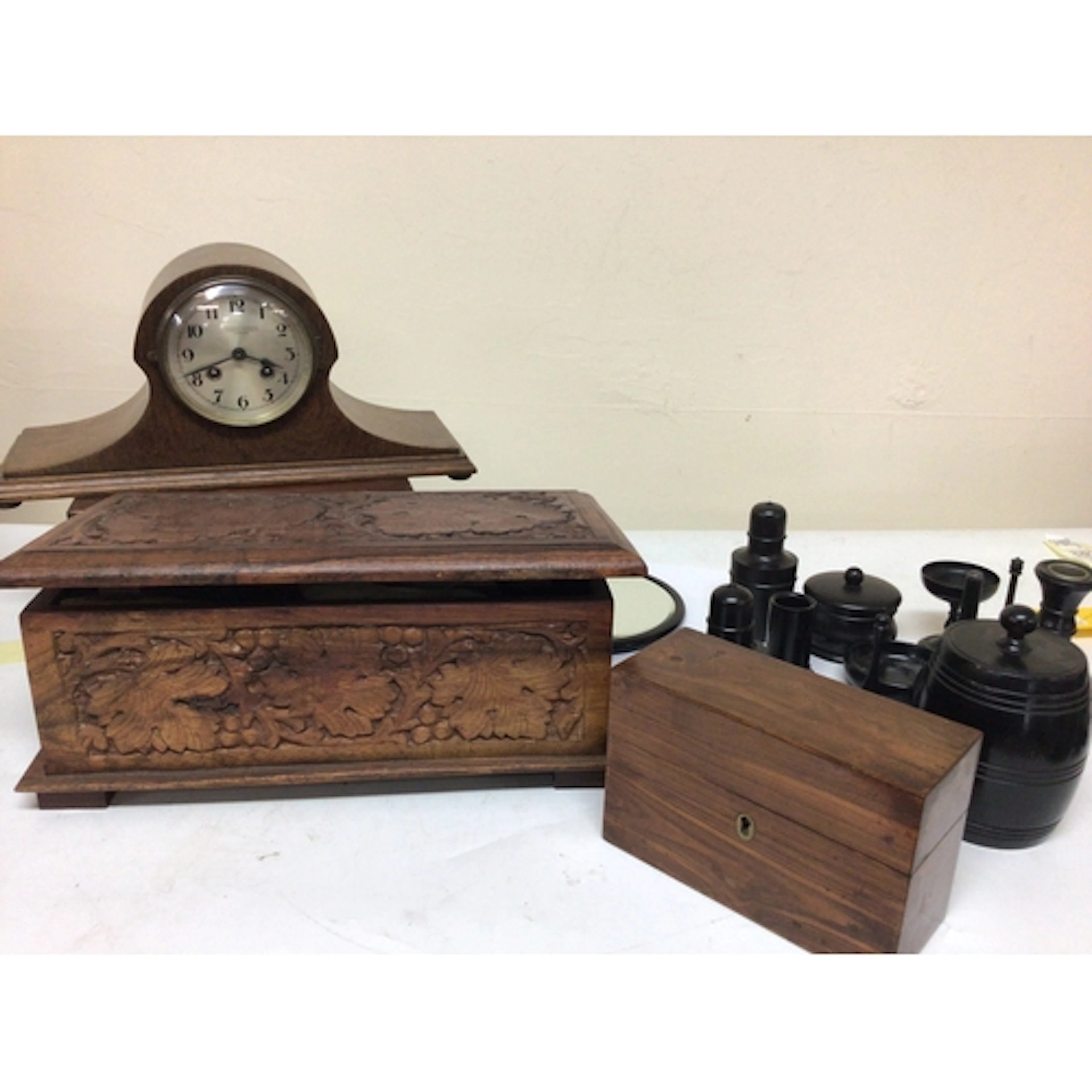 A Collection of ebony jars storage vessels a small bar...