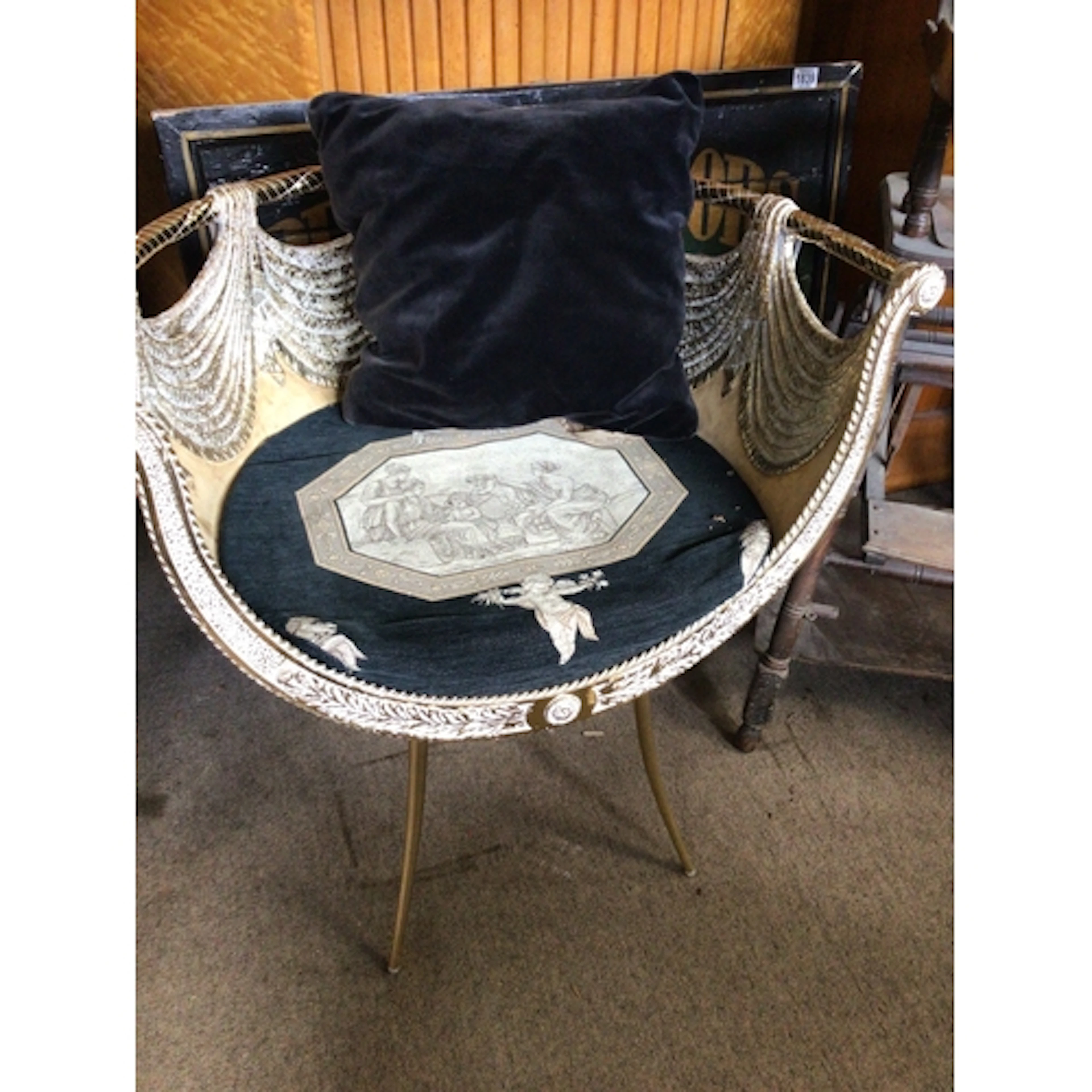 A Versace Style gilt metal chair the seat with a Roman inspi...