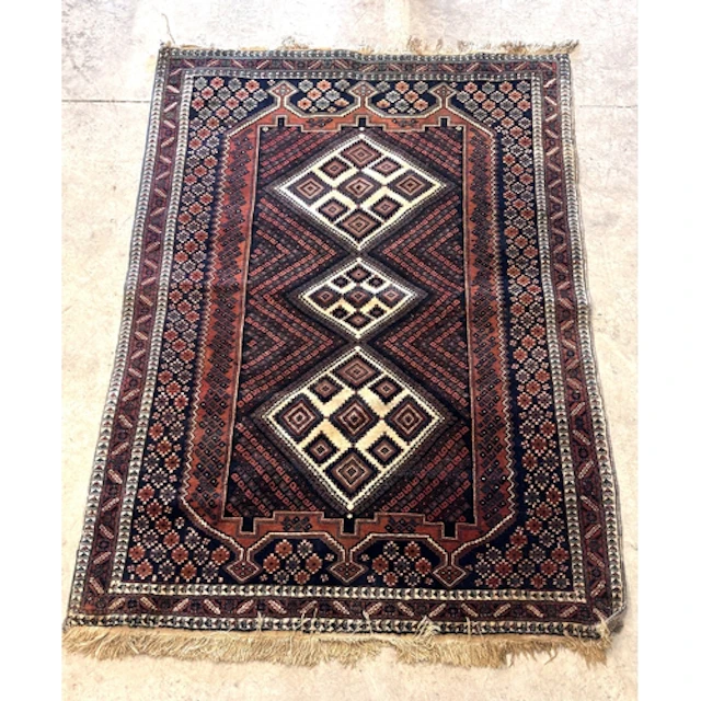 A hand-knotted Persian Afshar rug, with a central triple loz...