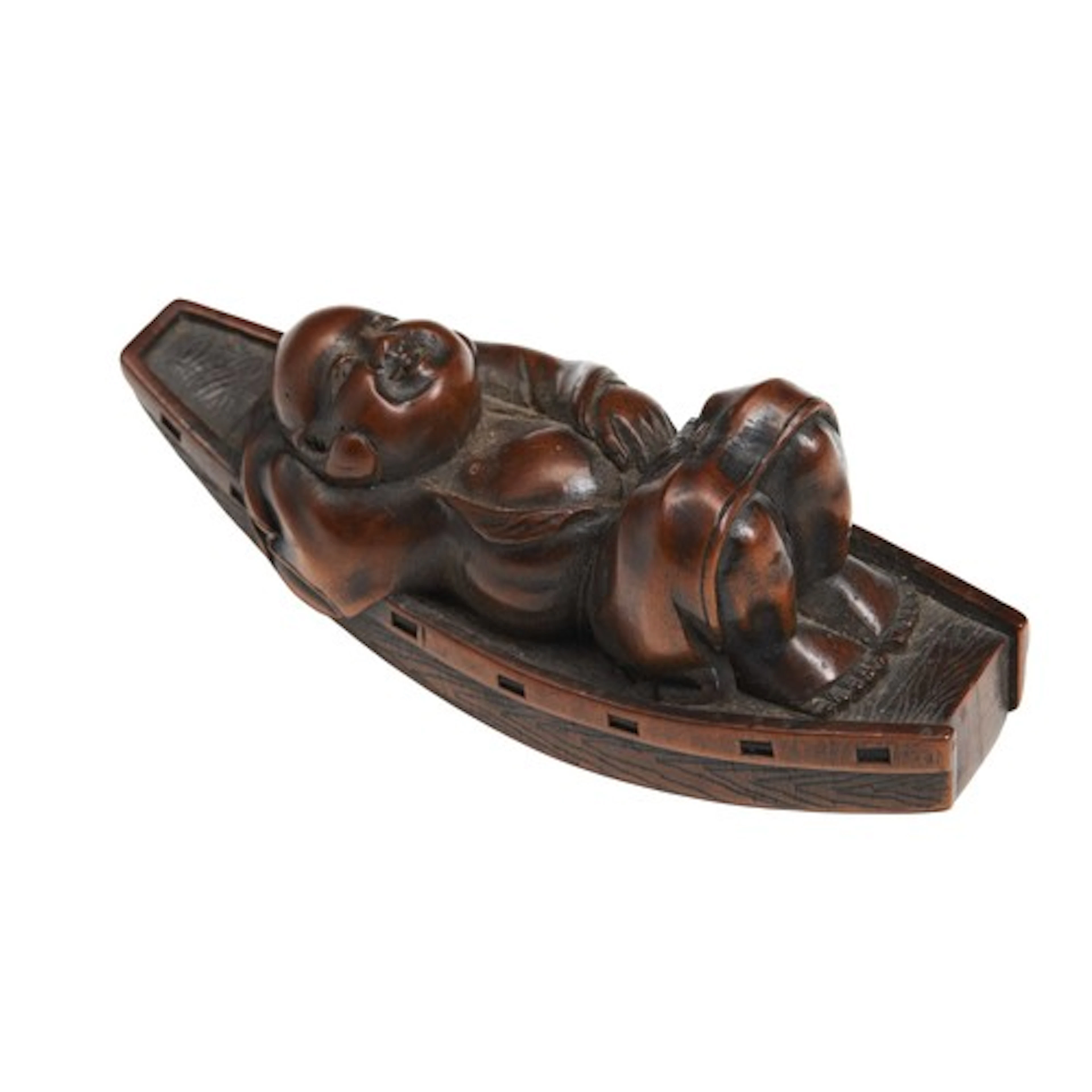 A FINE JAPANESE CARVED WOOD NETSUKE OF HOTEI ON A BOAT ATTRI...