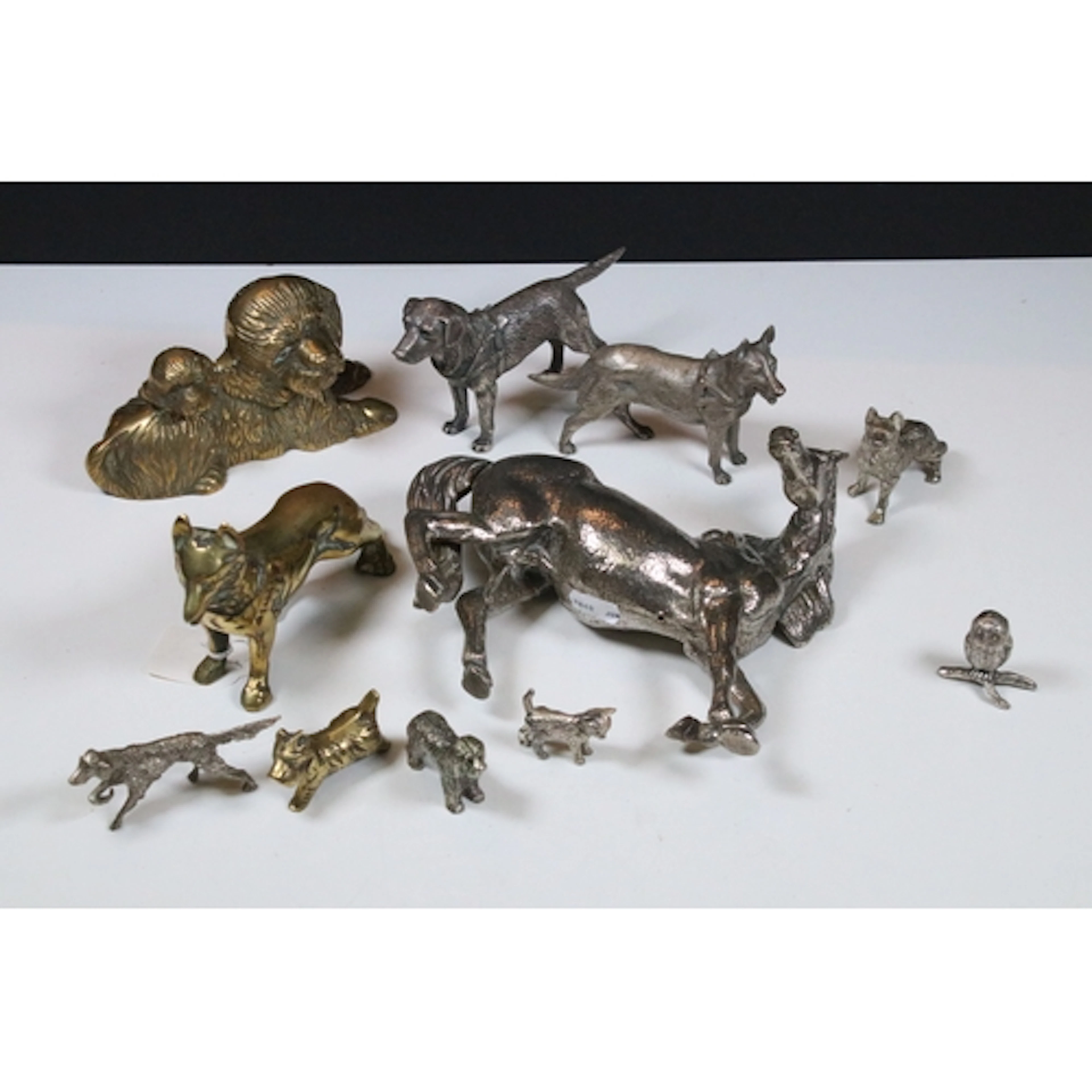 Group of cast metal animals, to comprise brass dogs, a group...