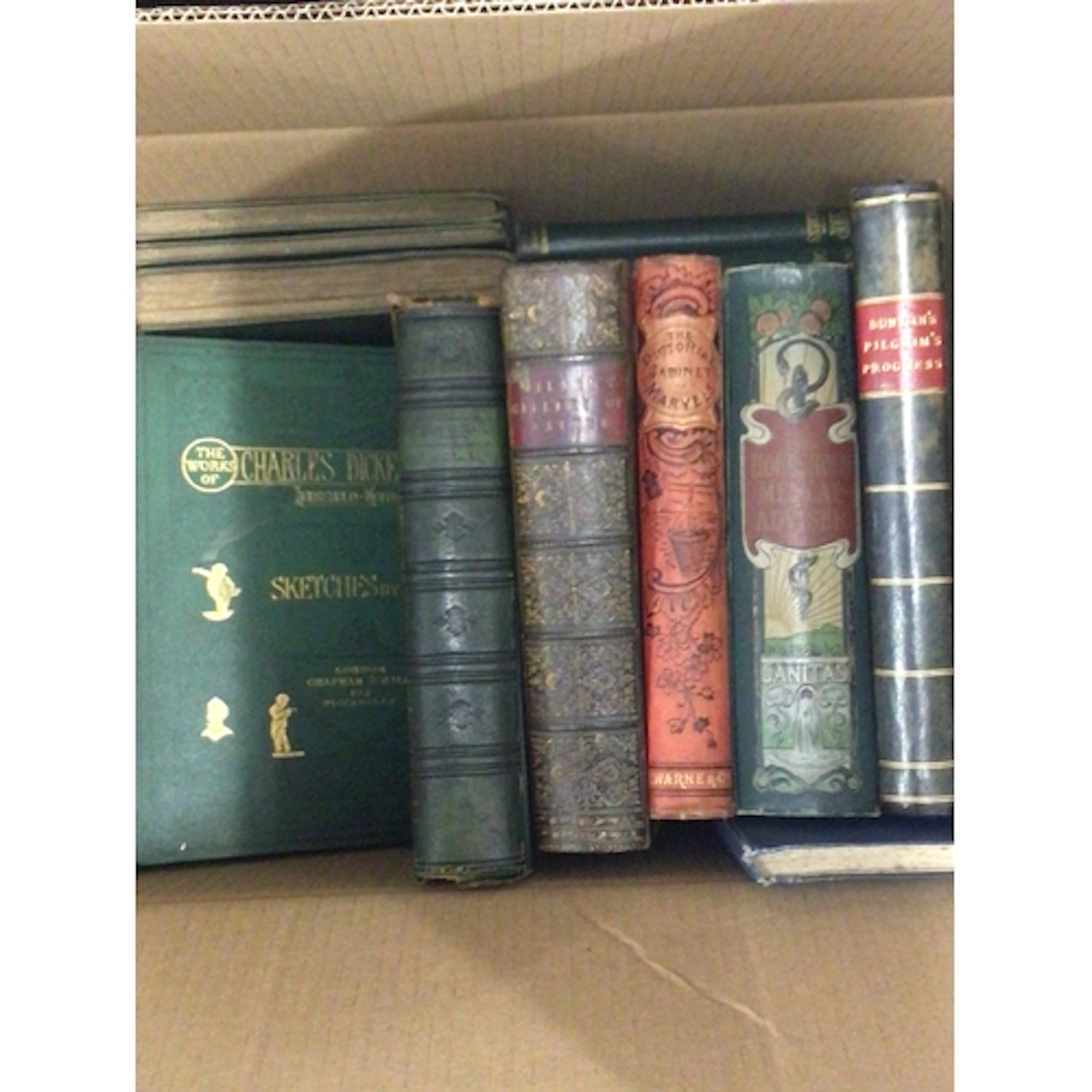 A box containing antique books The Hose Hold Medical A...