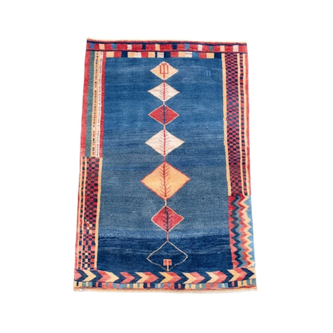 An Iranian Gabbeh rug. 100% wool pile, the blue ground decor...