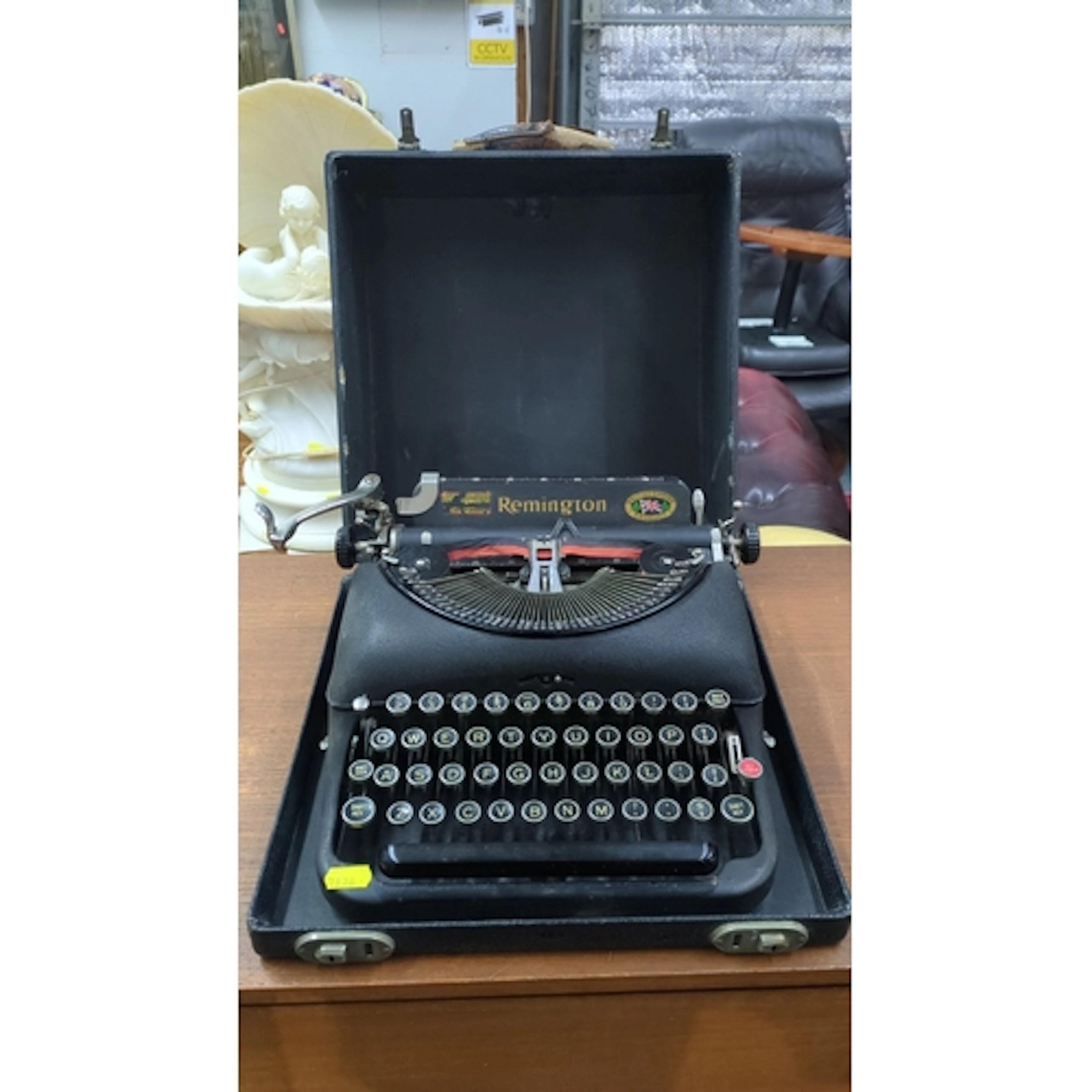 Remington portable typewriter in black crinkle-finish case; ...
